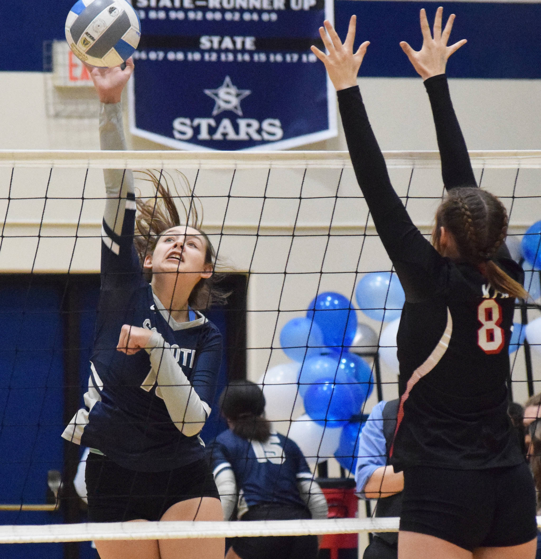 Soldotna’s Trayce Lyon puts a ball by Kenai Central blocker Baileigh Skorupa, Friday, Oct. 18, 2019, at Soldotna High School in Soldotna, Alaska. (Photo by Joey Klecka/Peninsula Clarion)