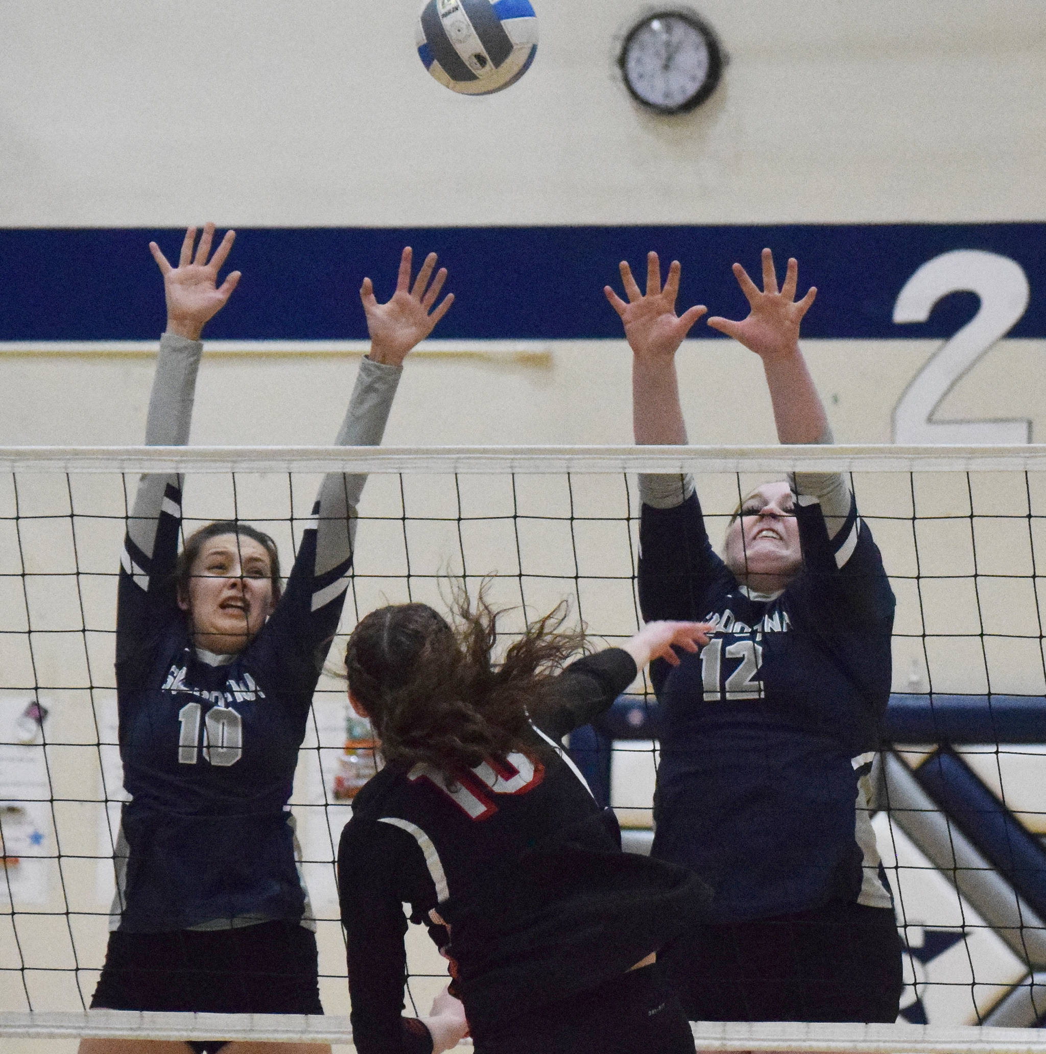 Soldotna’s Trayce Lyon and Bailey Armstrong team up for a block on Kenai Central’s Abby Every, Friday, Oct. 18, 2019, at Soldotna High School in Soldotna, Alaska. (Photo by Joey Klecka/Peninsula Clarion)