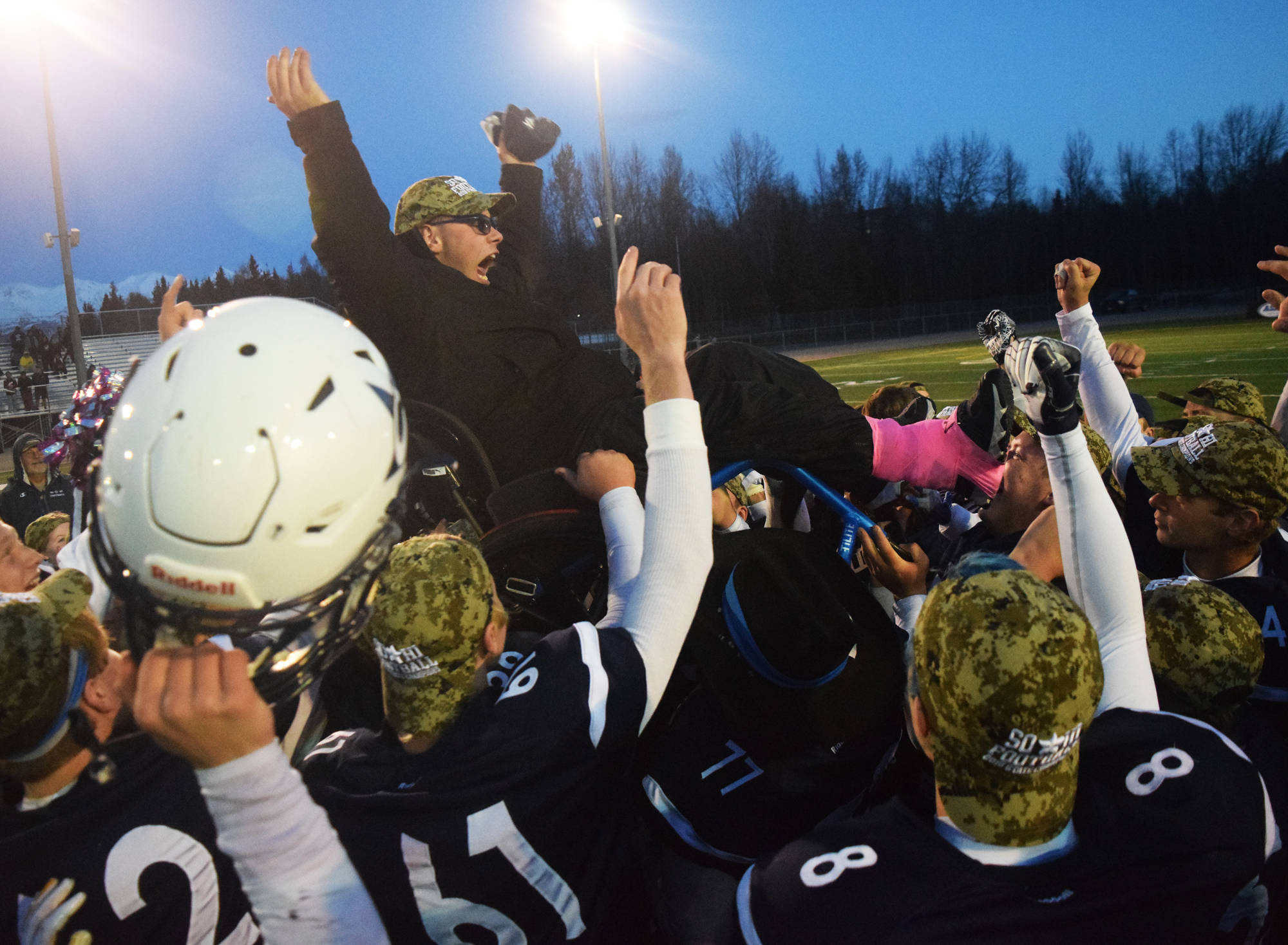 Members of the Soldotna football team lift up team manager Matthew Martinelli after winning Saturday, Oct. 19, 2019, at the Div. II state football championship at Anchorage Football Stadium in Anchorage, Alaska. The Stars defeated Lathrop 69-23. (Photo by Joey Klecka/Peninsula Clarion)