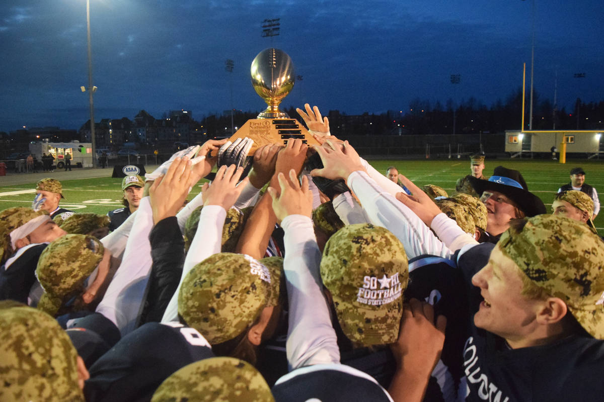 Members of the Soldotna football team celebrate with the Alaska School Activities Association First National Bowl trophy Saturday, Oct. 19, 2019, at the Div. II state football championship at Anchorage Football Stadium in Anchorage, Alaska. (Photo by Joey Klecka/Peninsula Clarion)