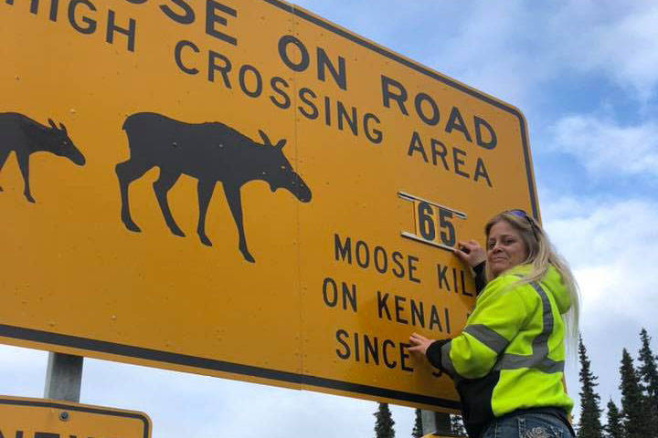 Photo courtesy Laurie Speakman                                Laurie Speakman updates a moose crossing sign in Soldotna on Oct. 10.