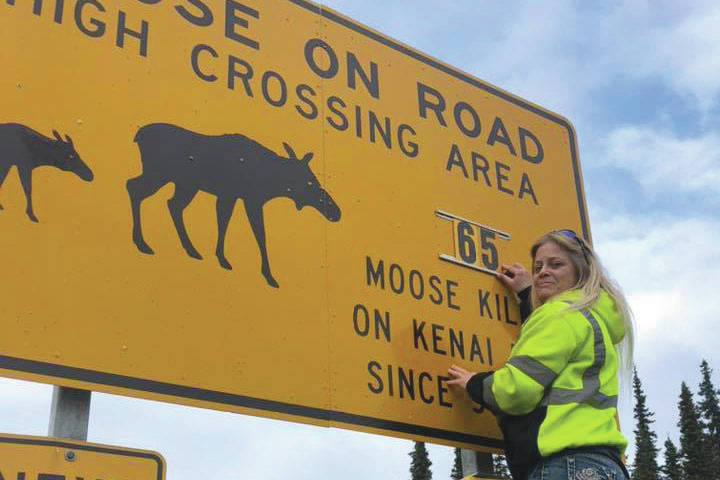 Laurie Speakman is seen here updating a moose crossing sign in Soldotna, Alaska on Oct. 10, 2019. (Photo courtesy Laurie Speakman)
