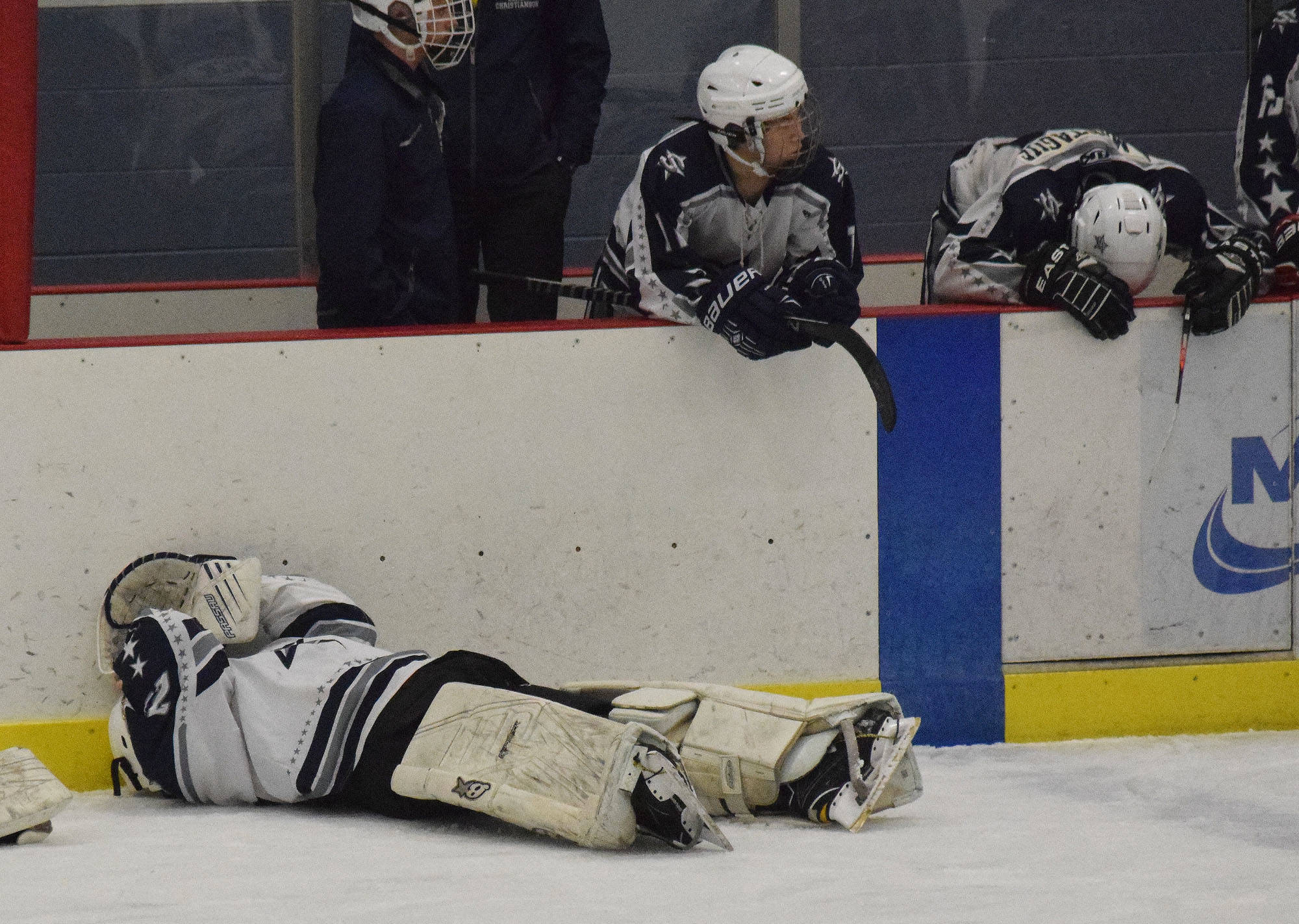 Members of the Soldotna hockey team react Friday after losing to Palmer in overtime in a state semifinal contest at the Curtis Menard Sports Complex in Wasilla. (Photo by Joey Klecka/Peninsula Clarion)