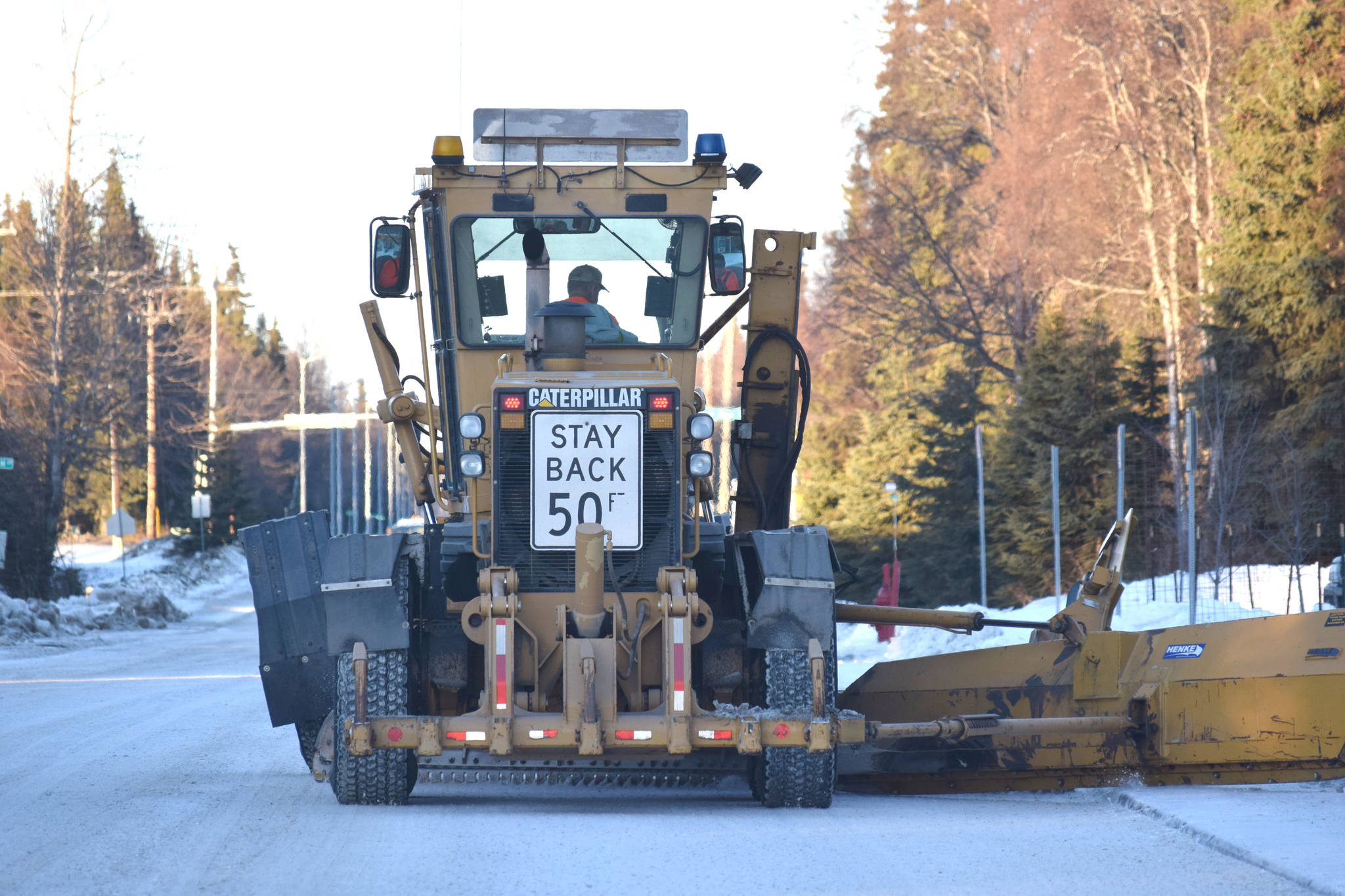 A contractor plows snow down Forest Drive in Kenai on Jan. 17, 2019. (Photo by Brian Mazurek/Peninsula Clarion)
