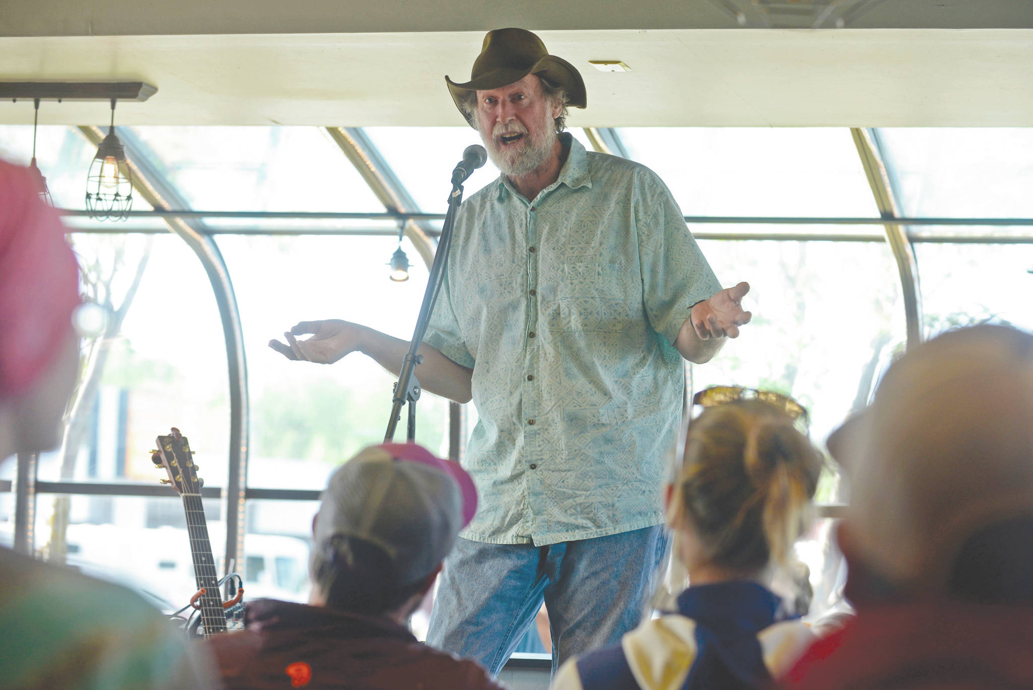 Ben Boettger/Peninsula Clarion file                                Bill Holt tells a fishing tale at Odie’s Deli on Friday, June 2, 2017, in Soldotna. Holt was among the seven storytellers in True Tales Told Live, an occasional storytelling event co-founded by Pegge Erkeneff, Jenny Neyman and Kaitlin Vadla.