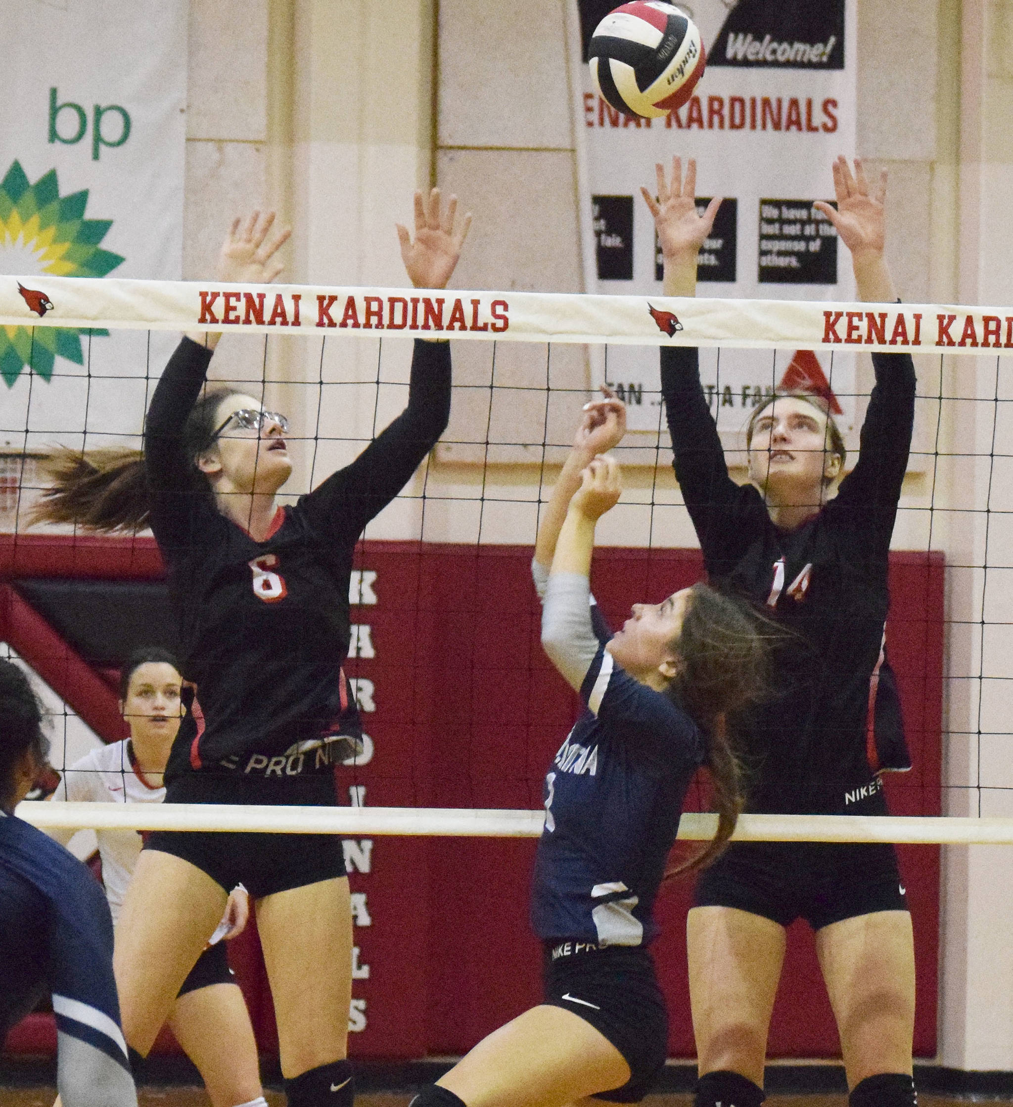 Brooke Ashley and Erin Koziczkowski team up for a block on Soldotna’s Sierra Kuntz Thursday, Oct. 31, 2019, at Kenai Central High School in Kenai, Alaska. (Photo by Joey Klecka/Peninsula Clarion)