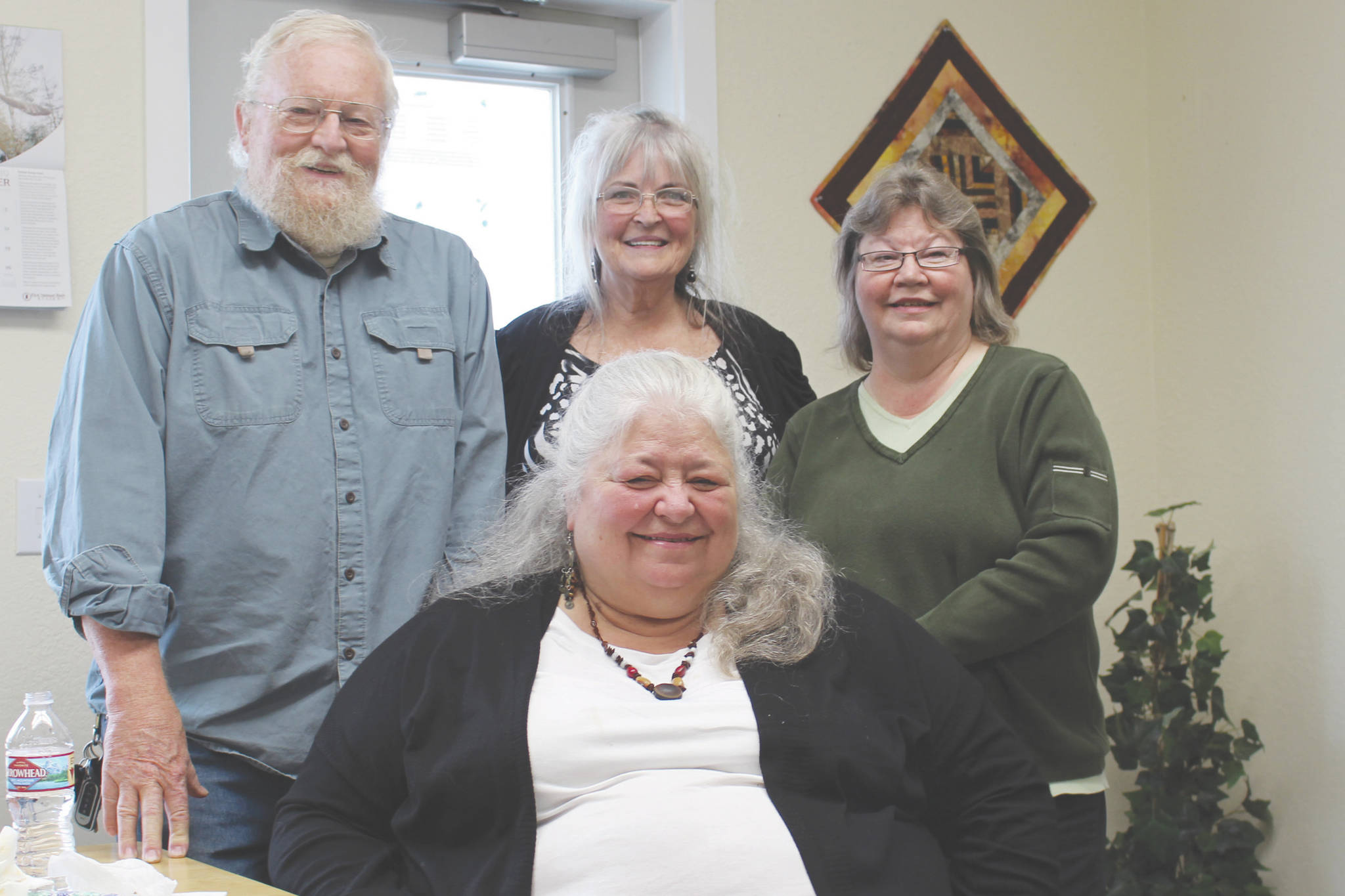 Grand Group members Joe Carlson, left, Nancy Carlson, front center, Sue Gill, back center and Vicki Fruichantie, right smile for the camera at the Children’s Advocacy Center in Kenai, Alaska on Oct. 3, 2019. (Photo by Brian Mazurek/Peninsula Clarion)