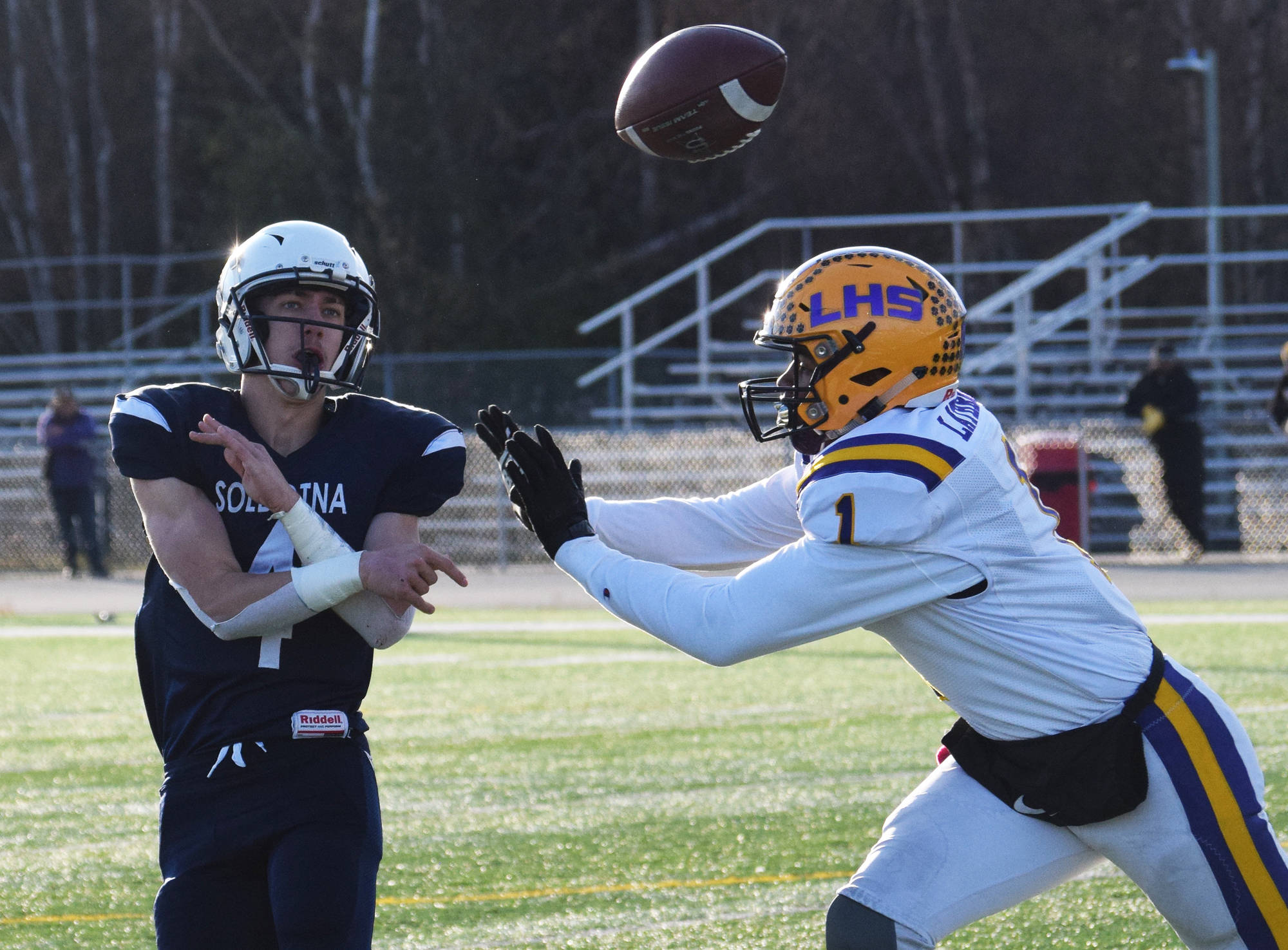 Soldotna quarterback Jersey Truesdell throws a pass with pressure from Lathrop’s Jace Henry, Saturday, Oct. 19, 2019, at the Div. II state football championship at Anchorage Football Stadium in Anchorage, Alaska. (Photo by Joey Klecka/Peninsula Clarion)