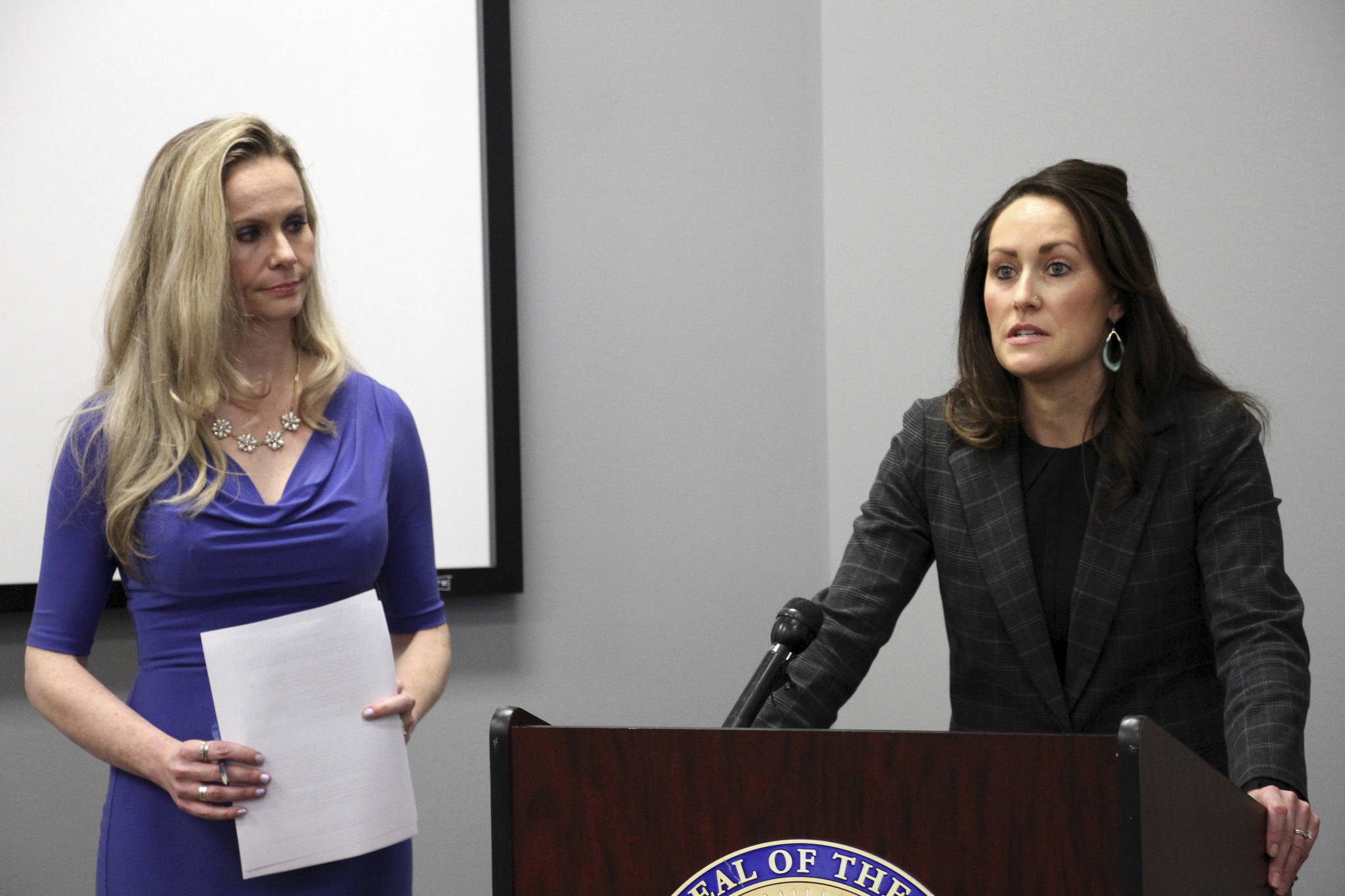 Alaska Department of Administration Commissioner Kelly Tshibaka, left, and Alaska Public Defender Samantha Cherot discuss a report Monday, Nov. 4, 2019, in Anchorage, Alaska, that says the public defender agency is passing off more cases to the Office of Public Advocacy due to conflicts of interest with other cases or clients. The report from a state oversight unit says the number of conflicts jeopardizes the primary defense role the agency plays. (AP Photo/Mark Thiessen)