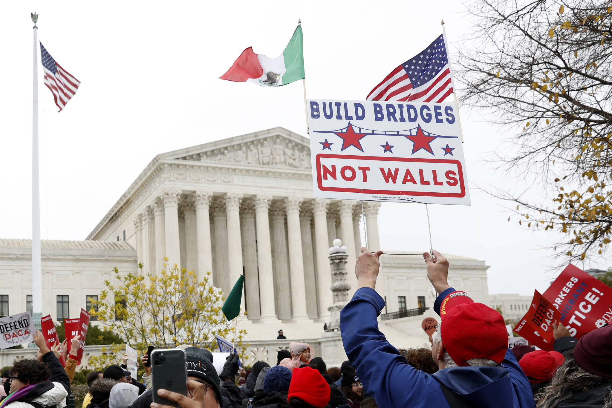 People rally outside the Supreme Court as oral arguments are heard in the case of President Trump’s decision to end the Obama-era, Deferred Action for Childhood Arrivals program (DACA), Tuesday, Nov. 12, 2019, at the Supreme Court in Washington. (AP Photo/Jacquelyn Martin)