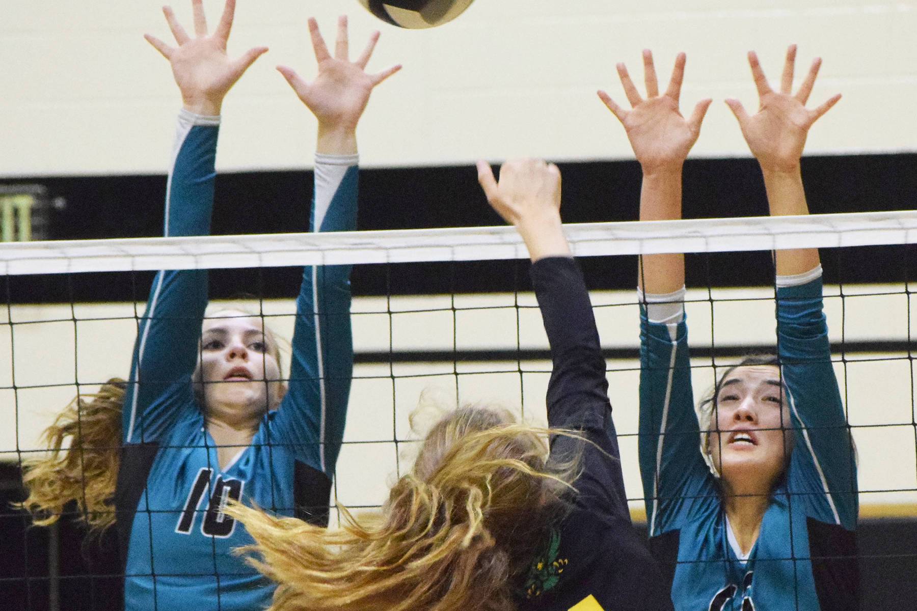 Nikiski teammates Lillian Carstens (left) and Tika Zimmerman team up for a block on Seward’s Shelby Sieminski, Thursday, Oct. 17, 2019, at Nikiski High School in Nikiski, Alaska. (Photo by Joey Klecka/Peninsula Clarion)