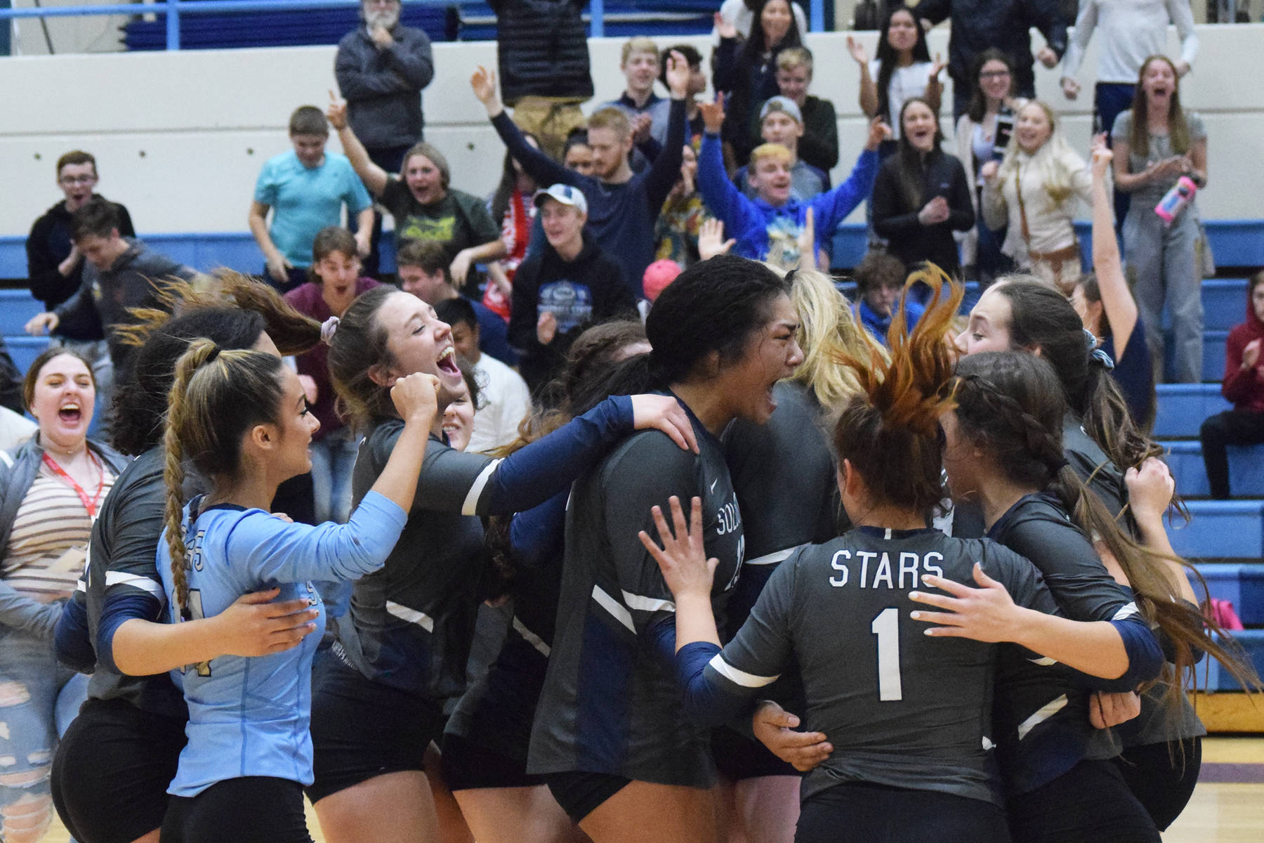The Soldotna volleyball team celebrates on the floor after beating Wasilla Thursday, Nov. 7, 2019, at the Northern Lights Conference tournament at Soldotna High School in Soldotna, Alaska. (Photo by Joey Klecka/Peninsula Clarion)