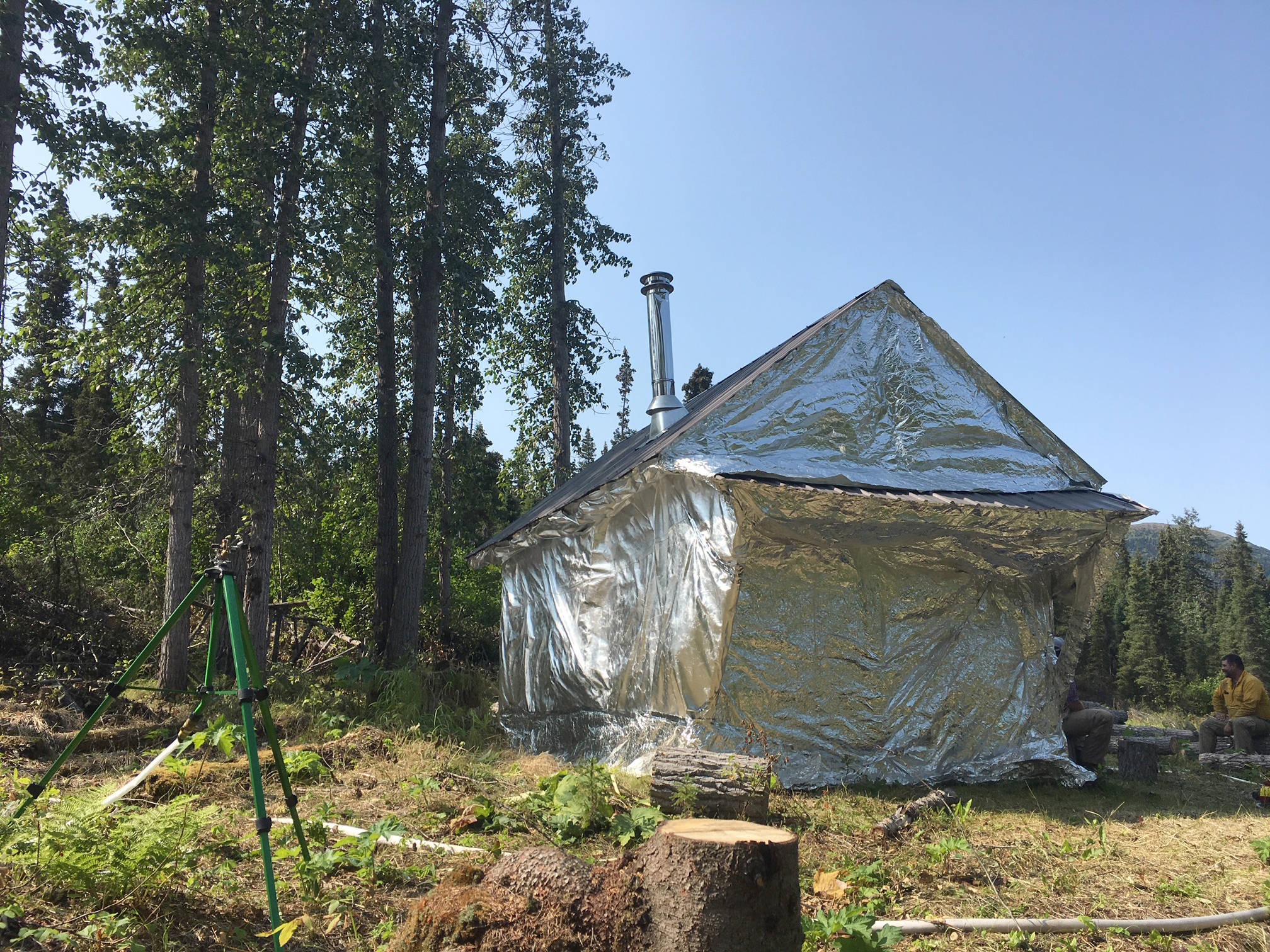 The Harry Johnson Trapline cabin was wrapped in a protective foil that is similar to the shelters wildland firefighters carry. (Photo provided by Kenai National Wildlife Refuge)
