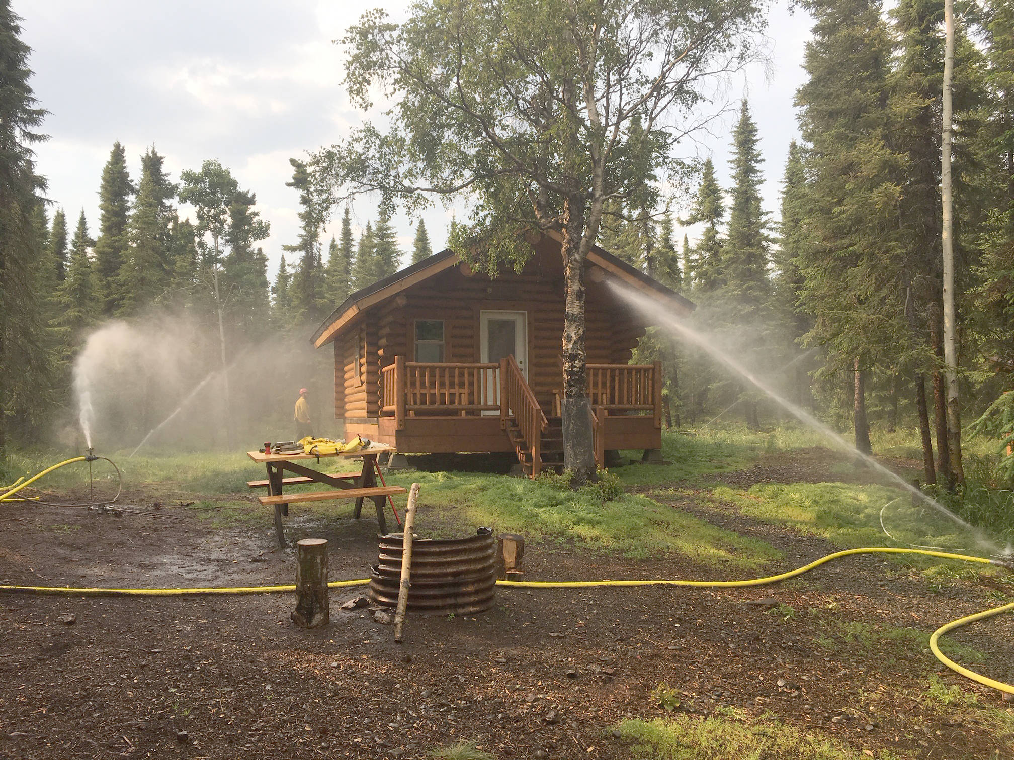 Sprinklers were used as one part of the structure protection plan for the Kelly Lake cabin. (Photo provided by Kenai National Wildlife Refuge)