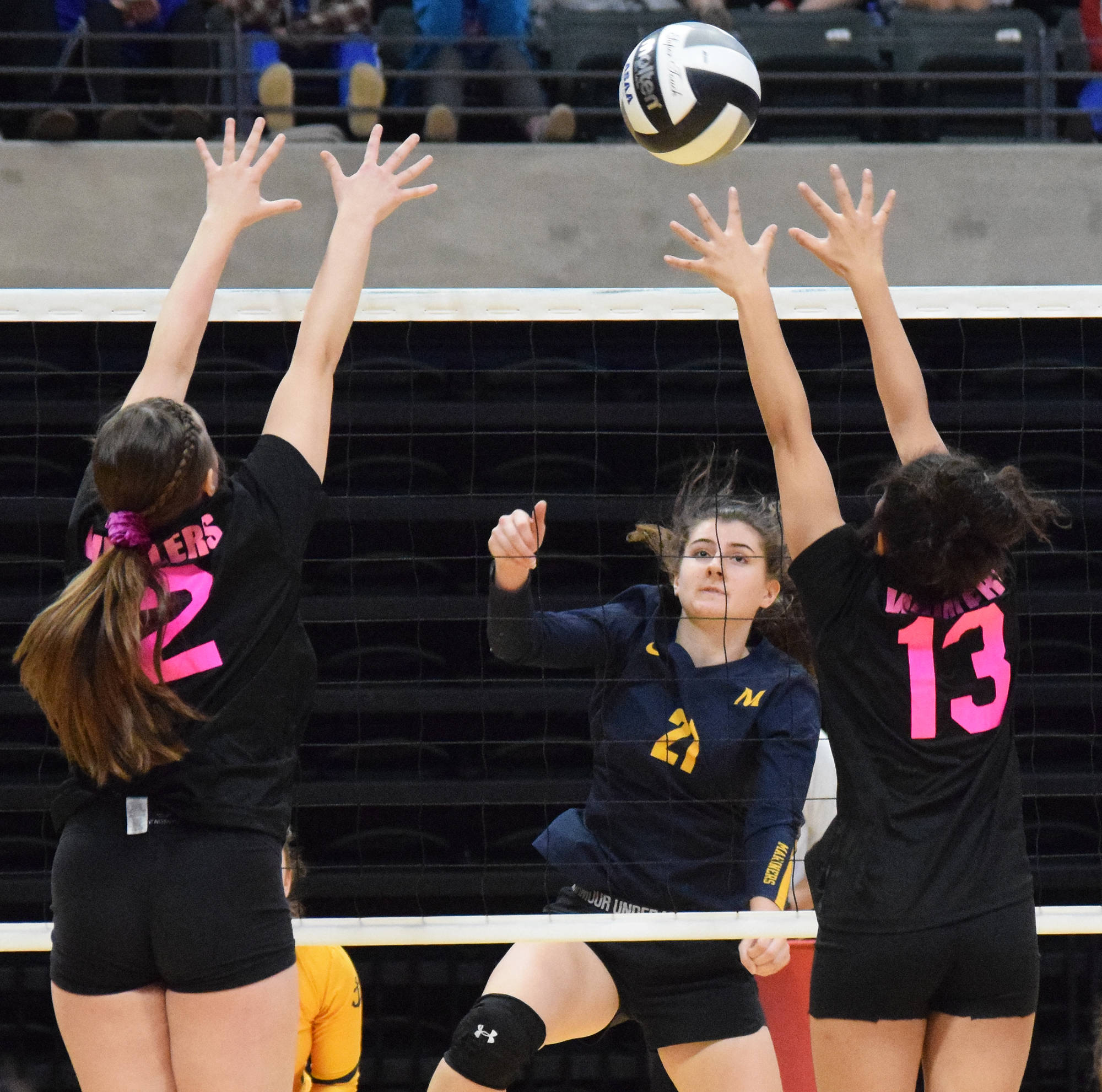 Homer’s Marina Carroll gets a shot by Barrow’s Alyssa Grimes (left) and Laela Mila, Friday, Nov. 15, 2019, at the Class 3A state volleyball tournament at the Alaska Airlines Center in Anchorage, Alaska. (Photo by Joey Klecka/Peninsula Clarion)
