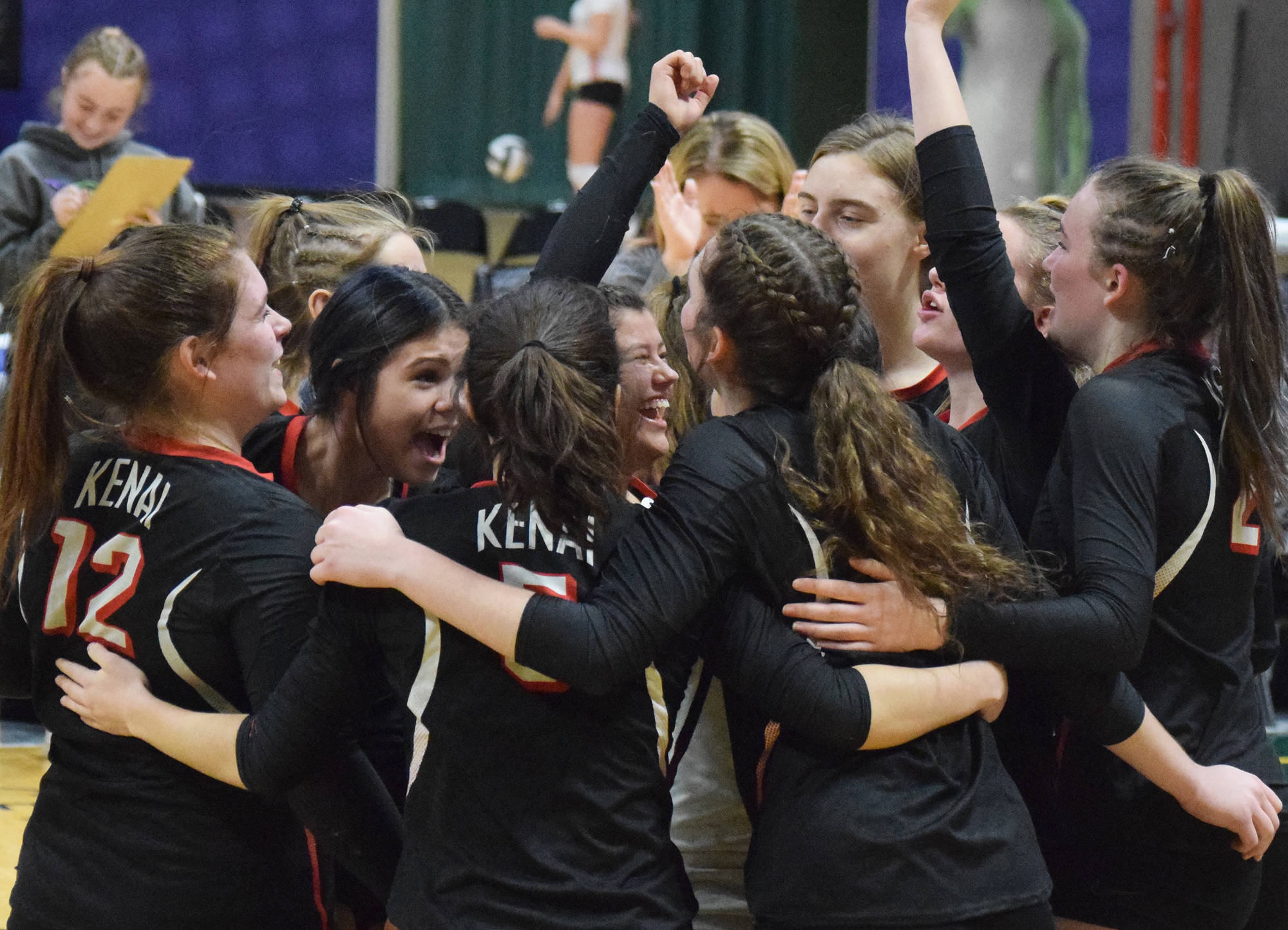 Kenai Central players celebrate after defeating Nikiski in a state semifinal Friday, Nov. 15, 2019, at the Class 3A state volleyball tournament at the Alaska Airlines Center in Anchorage, Alaska. (Photo by Joey Klecka/Peninsula Clarion)