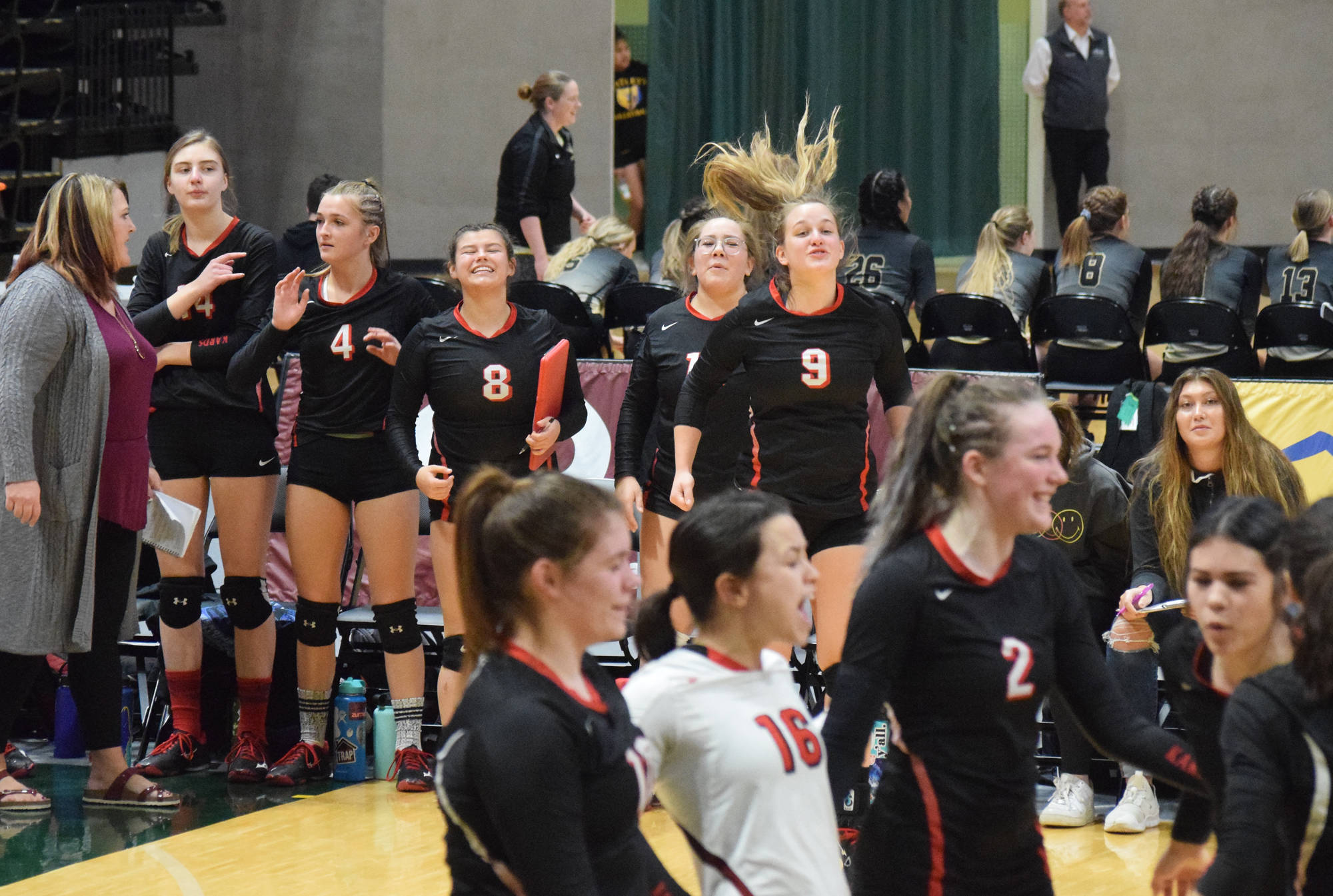 The Kenai Central bench cheers on the Kardinals Friday, Nov. 15, 2019, against Nikiski at the Class 3A state volleyball tournament at the Alaska Airlines Center in Anchorage, Alaska. (Photo by Joey Klecka/Peninsula Clarion)