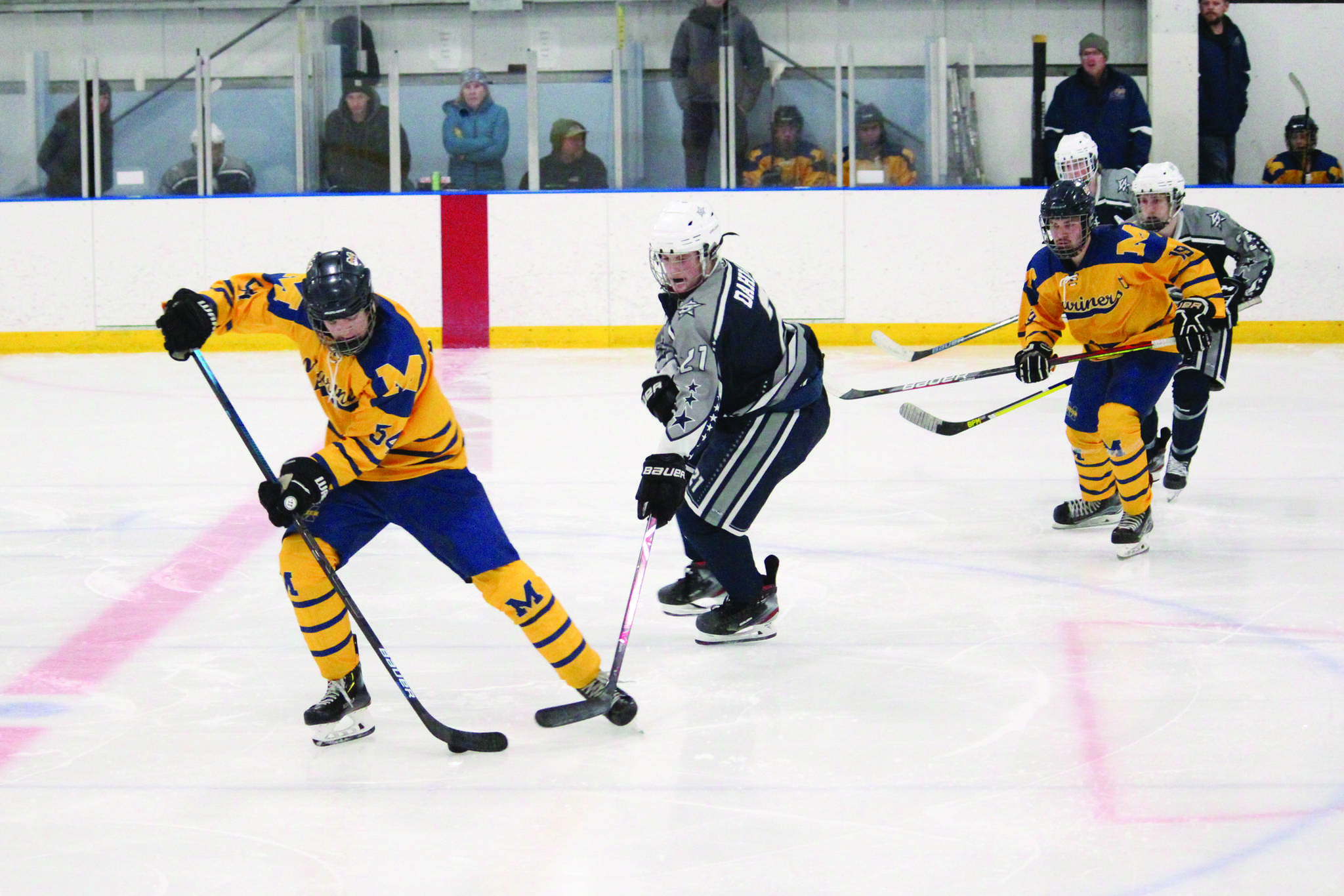 Homer’s Phinny Weston maneuvers the puck away from Soldotna’s Dylan Dahlgren during a Friday, Nov. 15, 2019 hockey game at Kevin Bell Arena in Homer, Alaska during the End of the Road Shootout tournament. (Photo by Megan Pacer/Homer News)