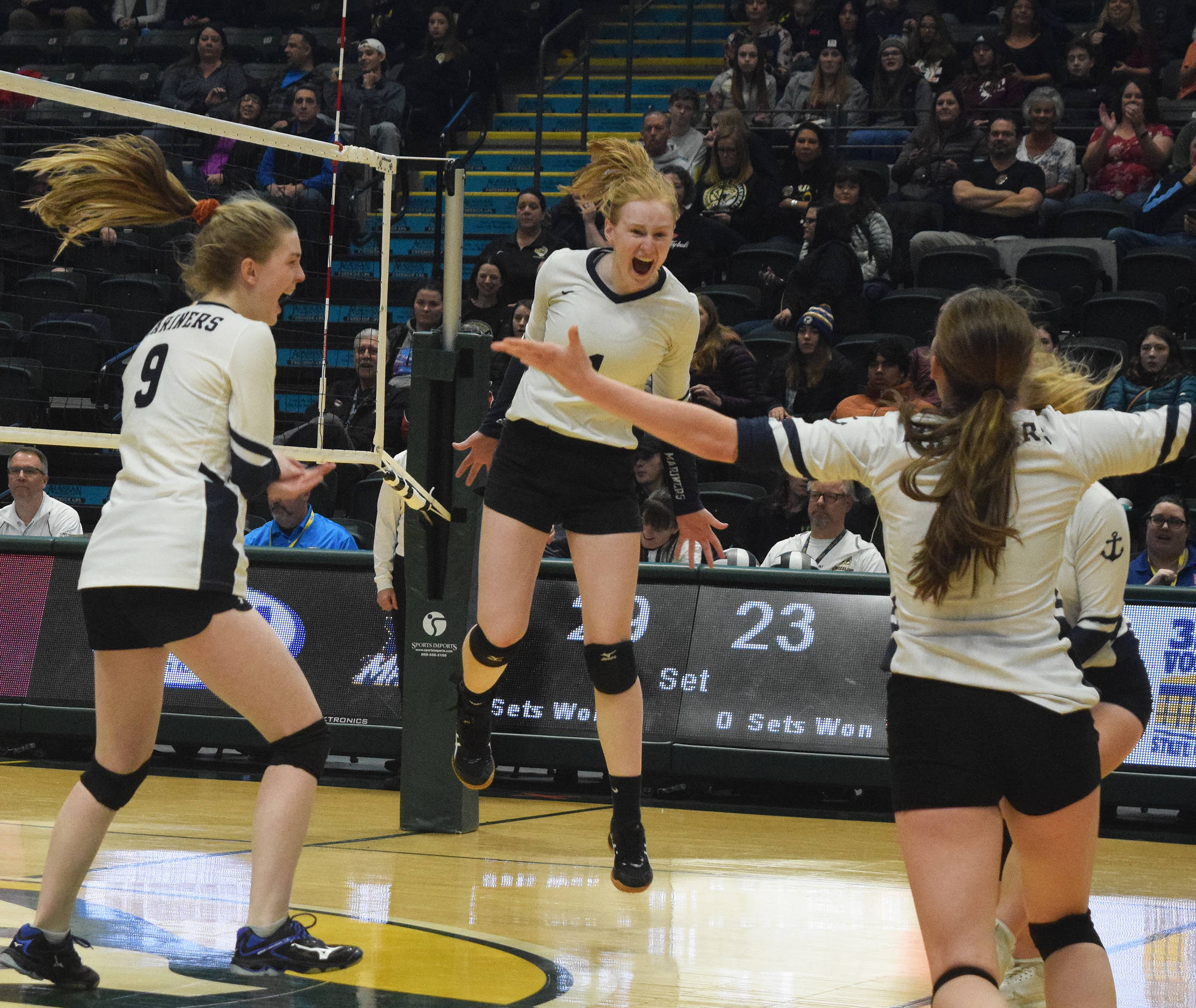 The Homer volleyball team celebrates after scoring the final point Saturday, Nov. 16, 2019, against Kenai Central at the Class 3A state volleyball tournament at the Alaska Airlines Center in Anchorage, Alaska. (Photo by Joey Klecka/Peninsula Clarion)