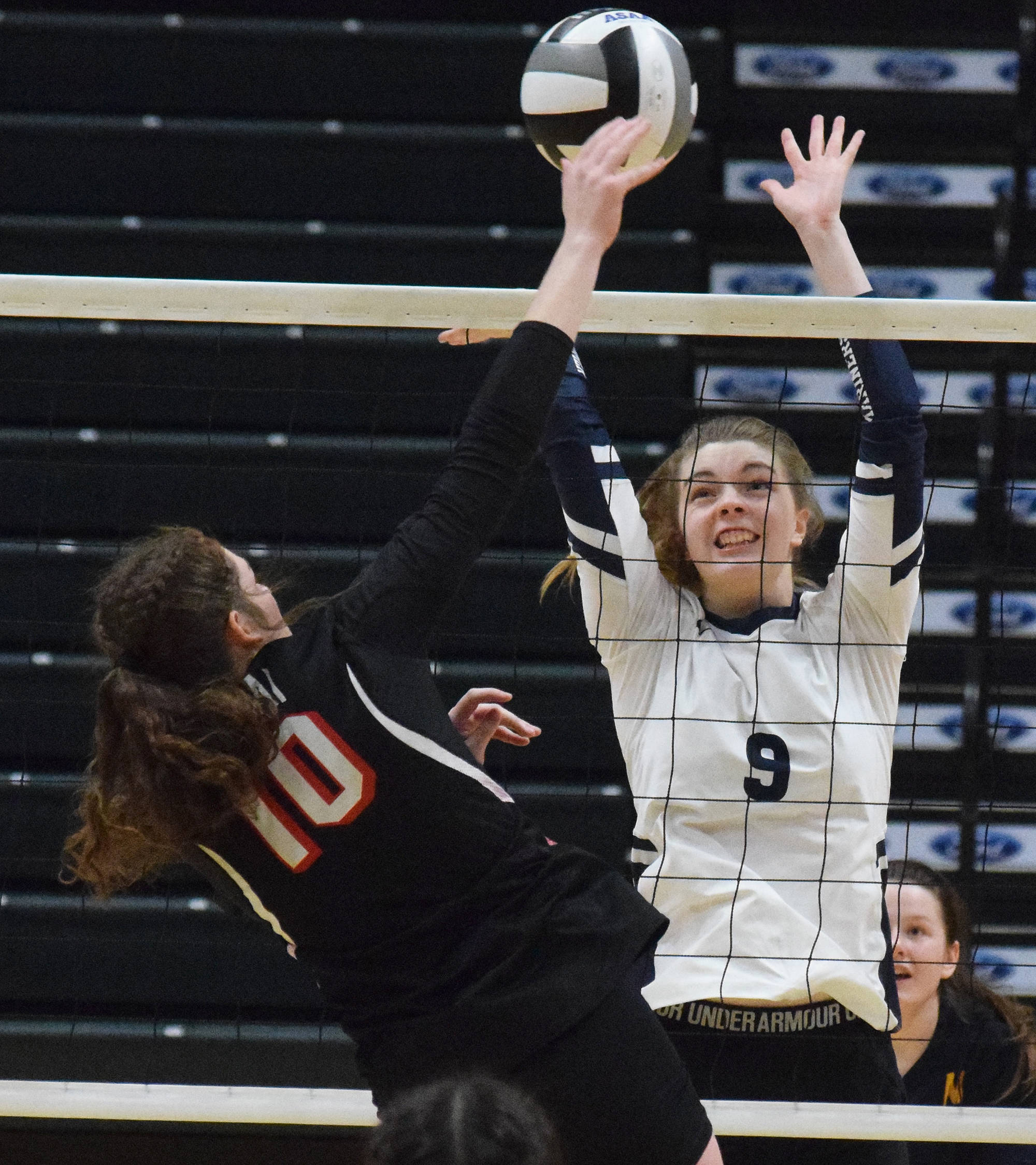 Homer’s Karmyn Gallios puts a block on Kenai’s Abby Every, Saturday, Nov. 16, 2019, at the Class 3A state volleyball tournament at the Alaska Airlines Center in Anchorage, Alaska. (Photo by Joey Klecka/Peninsula Clarion)
