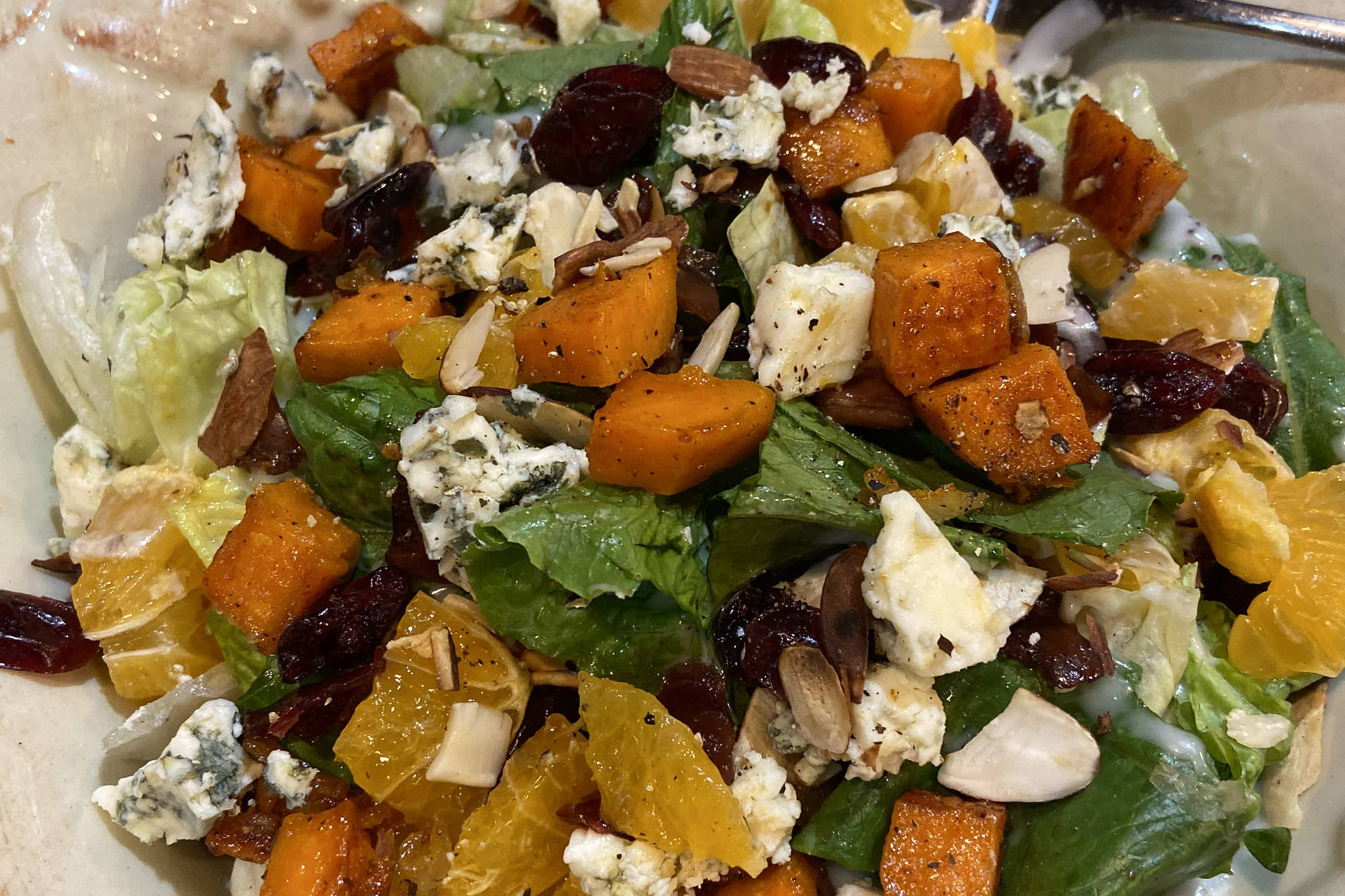 Roasted butternut squash tossed green salad offers a new take on traditional Thanksgiving meal flavors, as seen here ion Nov. 12, 2019, in Teri Robl’s kitchen in Homer, Alaska. (Photo by Teri Robl)