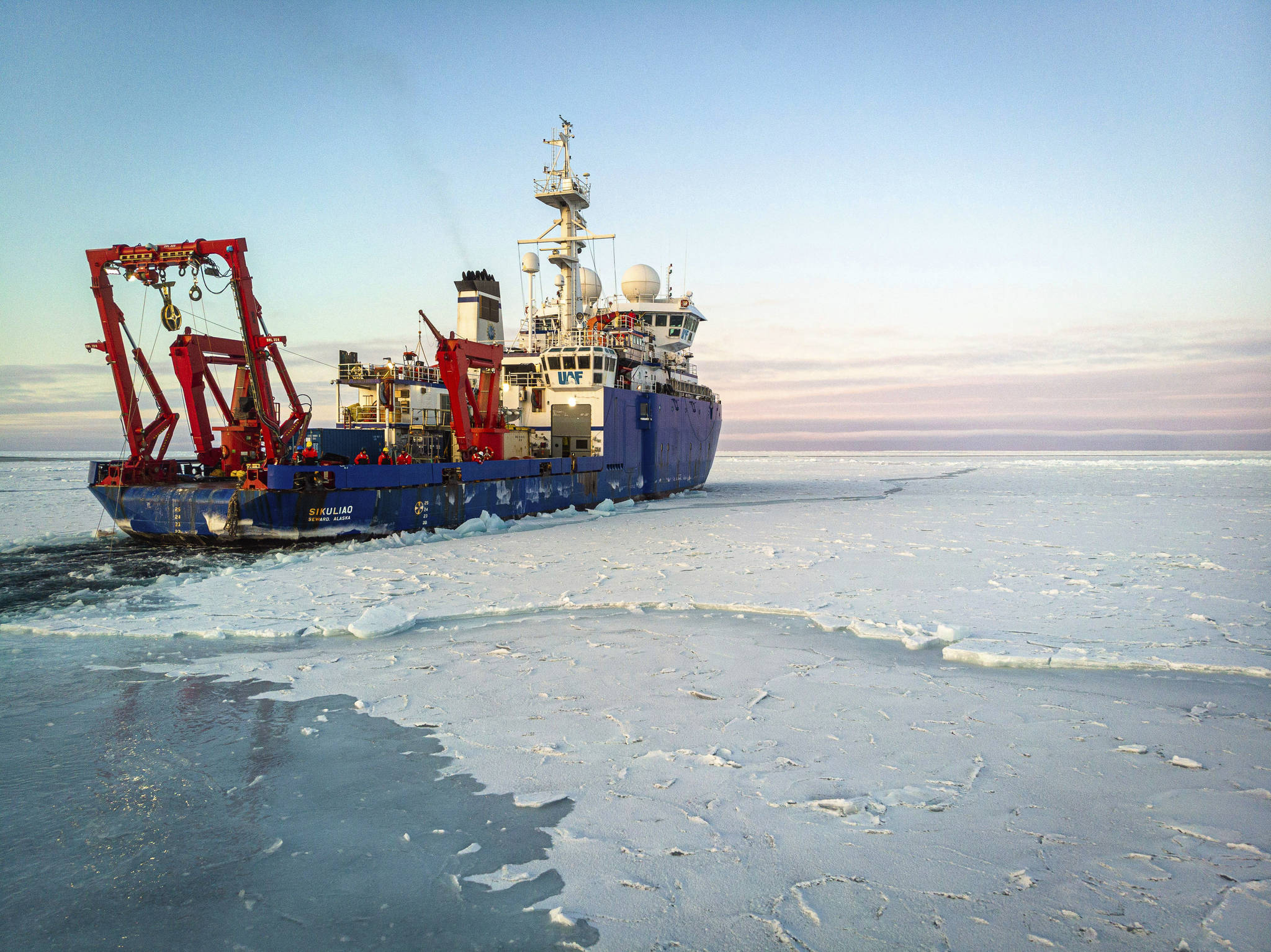 In this Nov. 14, 2019 photo provided by John Guillote and taken from an aerial drone shows the research vessel Sikuliaq as it makes its way through thin sea ice in the Beaufort Sea off Alaska’s north coast. University of Washington scientists onboard the research vessel are studying the changes and how less sea ice will affect coastlines, which already are vulnerable to erosion because increased waves delivered by storms. More erosion would increase the chance of winter flooding in villages and danger to hunters in small boats. (John Guillote via AP)
