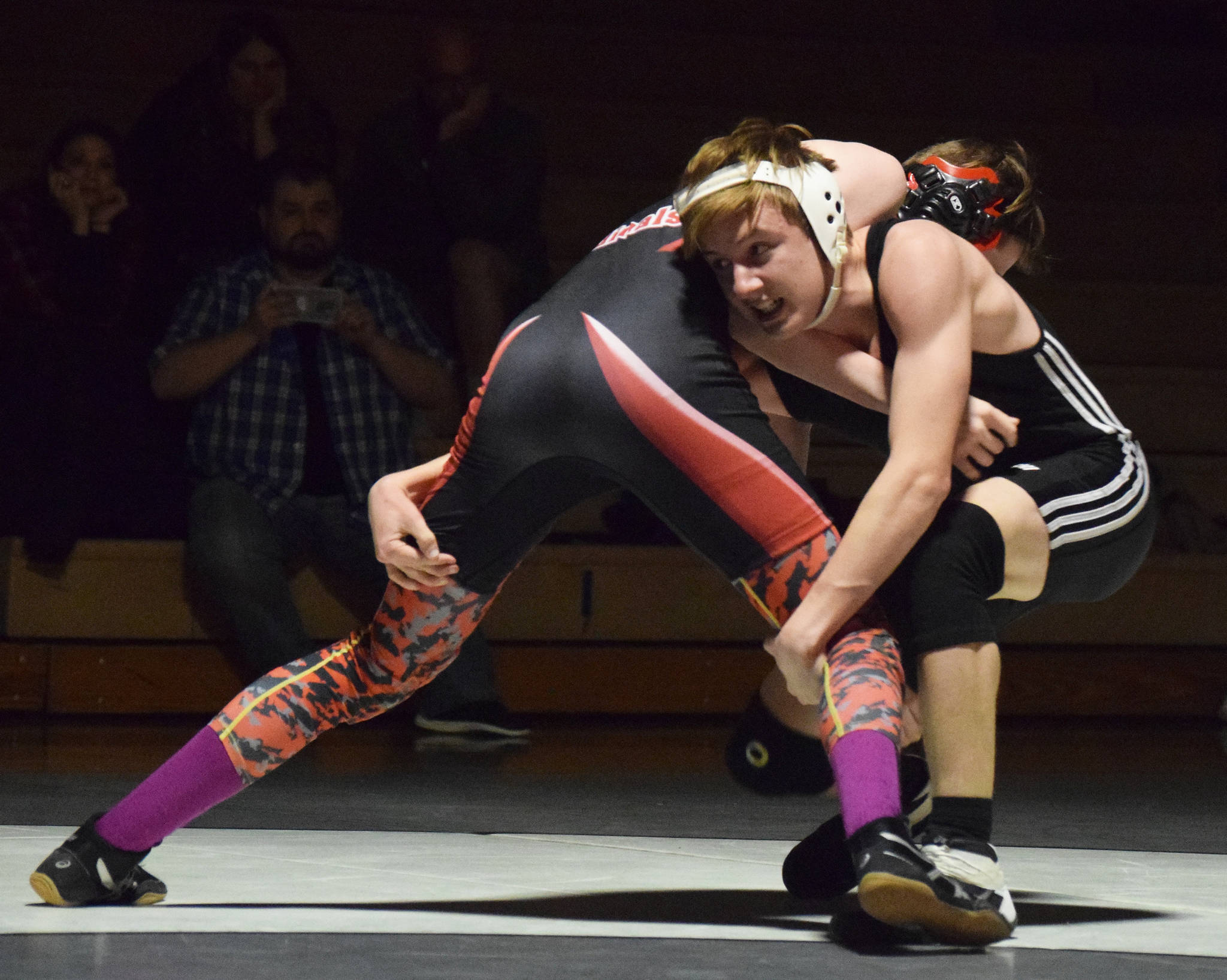 Nikiski’s Yorik Bastuck grapples with Kenai’s Isaiah Ticknor, Tuesday, Nov. 19, 2019, at a Kenai/Nikiski dual meet at Nikiski High School. (Photo by Joey Klecka/Peninsula Clarion)