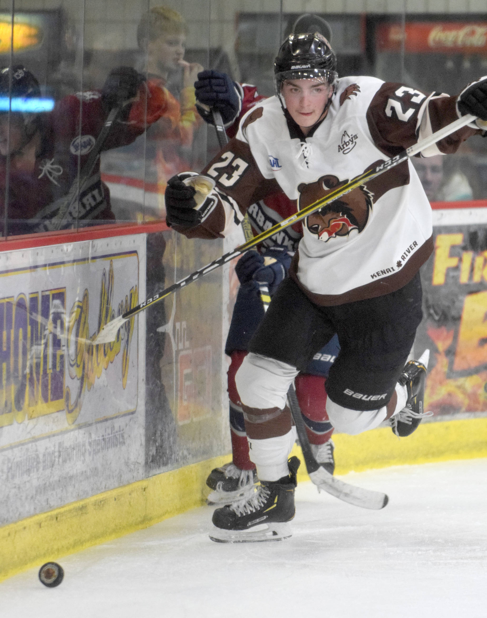 Kenai River Brown Bears forward Max Helgeson chases the puck along the boards against the Fairbanks Ice Dogs on Friday, Nov. 22, 2019, at the Soldotna Regional Sports Complex in Soldotna, Alaska. (Photo by Jeff Helminiak/Peninsula Clarion)