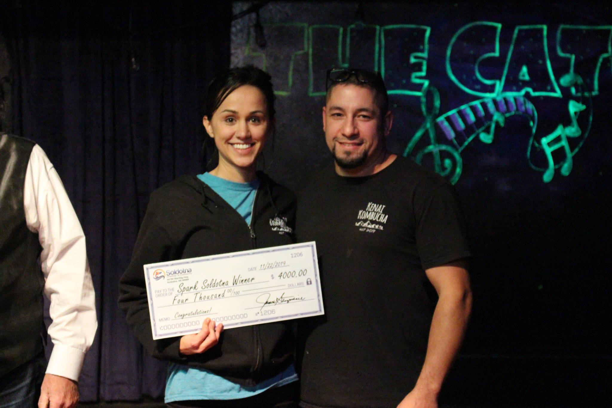 Devon and Brian Gonzalez smile with their check for $4,000 after being declared the winners of the Spark Soldotna competition at the Catch Restaurant in Soldotna, Alaska, on Friday, Nov. 22, 2019. (Photo by Brian Mazurek/Peninsula Clarion)