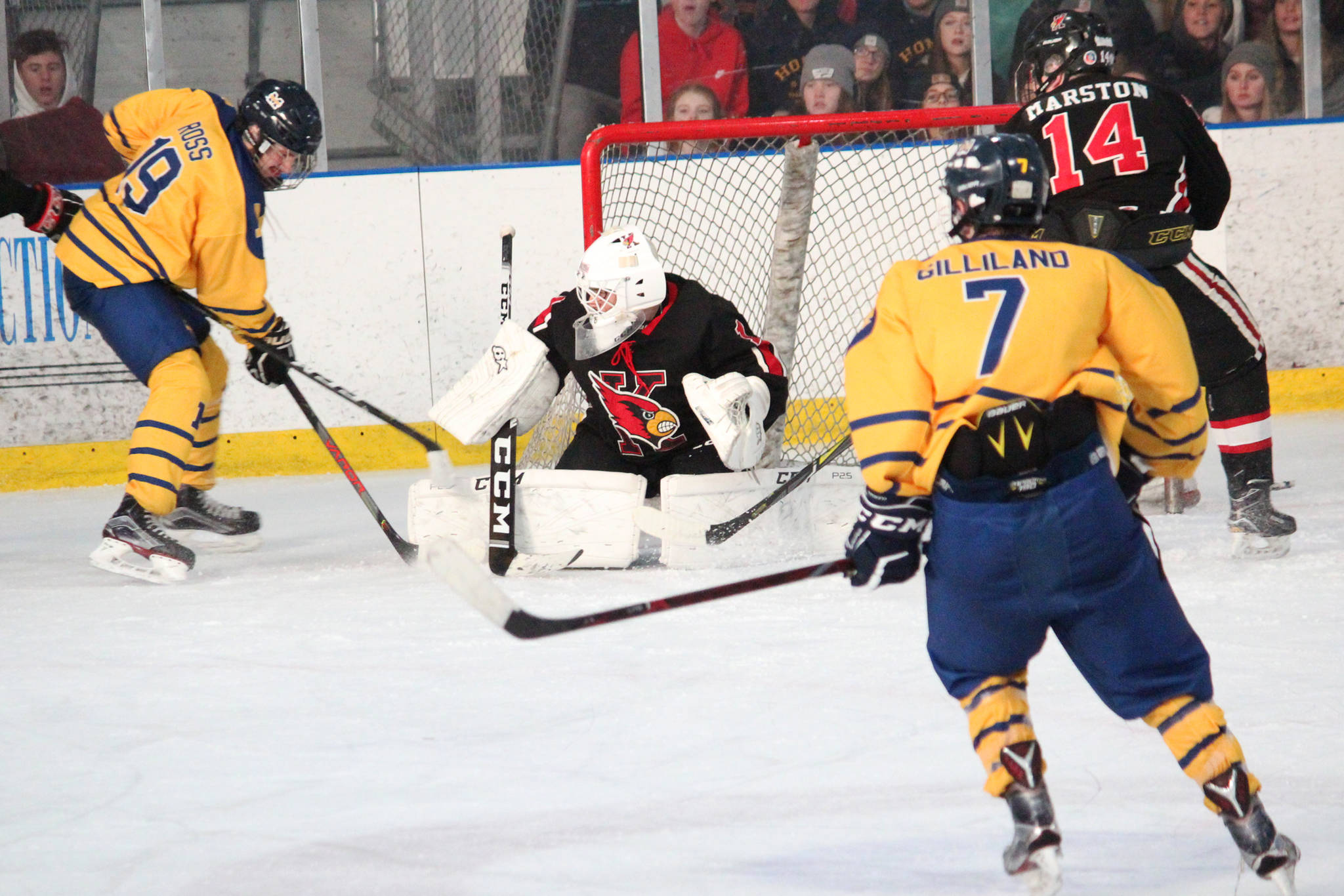 Homer’s Alden Ross (left) tries to get the puck past Kenai goalie Thomas Baker during a Saturday, Nov. 23, 2019 hockey game at Kevin Bell Arena in Homer, Alaska. (Photo by Megan Pacer/Homer News)