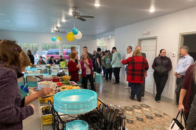 Residents of the Kenai Intentional Neighborhood celebrate the completion of their clubhouse with friends, family and Hope Community Resources board members in Soldotna, Alaska on Nov. 22, 2019. (Photo courtesy Kathy Fitzgerald)