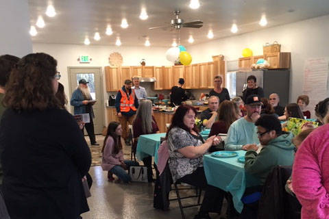 Residents of the Kenai Intentional Neighborhood celebrate the completion of their clubhouse with friends, family and Hope Community Resources board members in Soldotna, Alaska on Nov. 22, 2019. (Photo courtesy Kathy Fitzgerald)