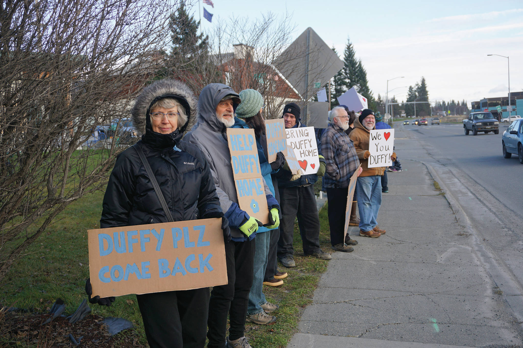 People hold signs Saturday, Nov. 23, 2019, at a vigil for Anesha “Duffy” Murnane, a Homer woman missing since Oct. 17, at WKFL Park in Homer, Alaska. (Photo by Michael Armstrong/Homer News)