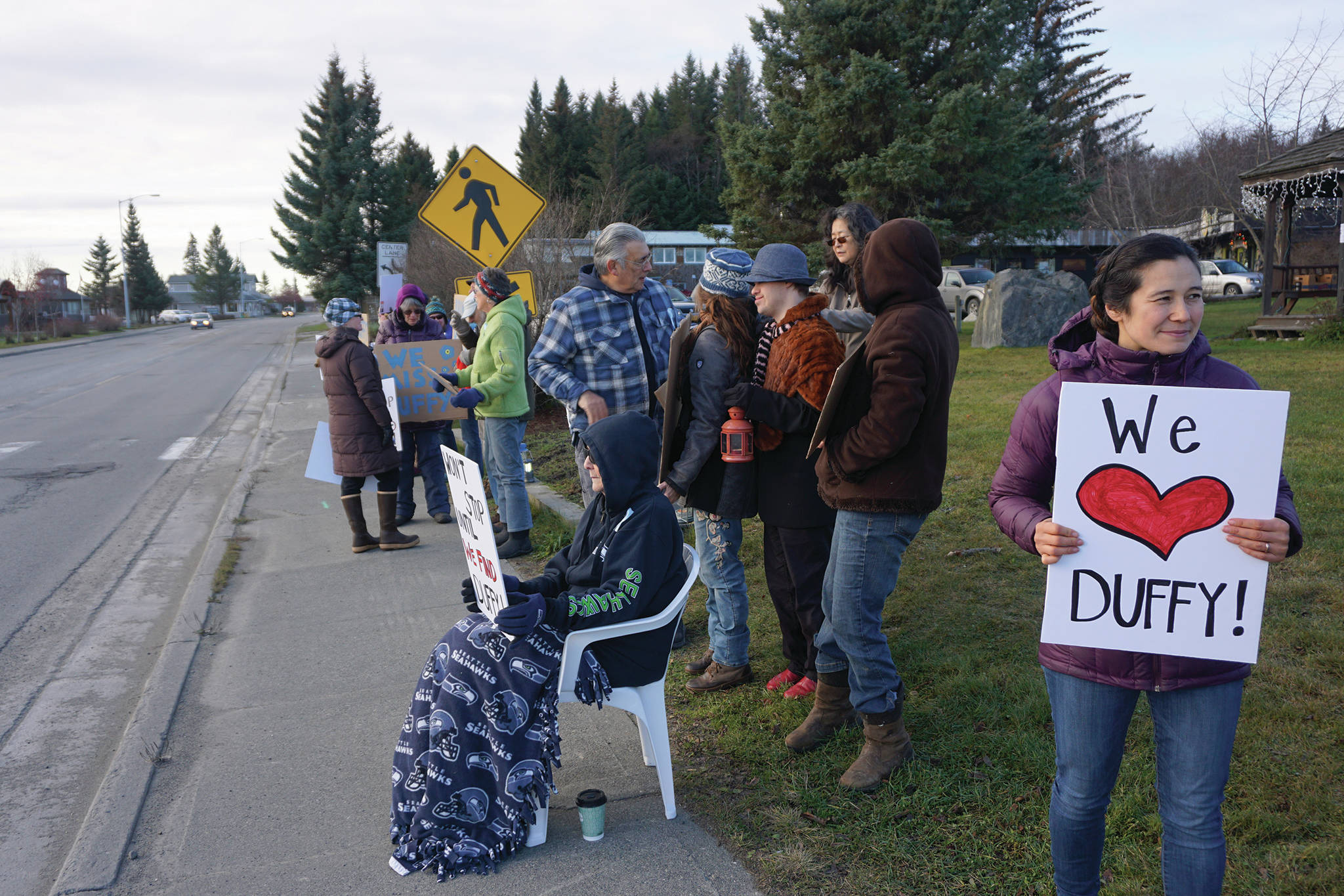 Tela Bacher holds a sign Saturday, Nov. 23, 2019, at a vigil for Anesha “Duffy” Murnane, a Homer woman missing since Oct. 17, at WKFL Park in Homer, Alaska. Sinn helped organize the vigil. (Photo by Michael Armstrong/Homer News)