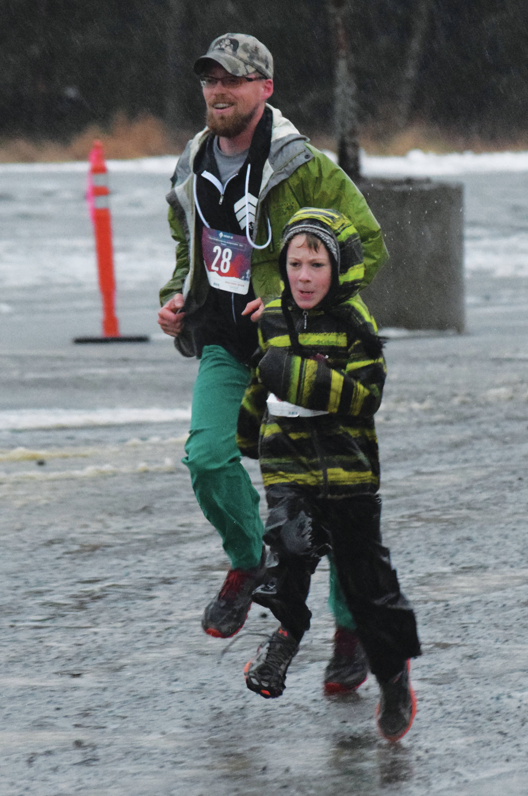 Soldotna’s Derek Black and Daniel Warner approach the finish line Thursday, Nov. 28, 2019, at the Turkey Trot in Soldotna, Alaska. (Photo by Joey Klecka/Peninsula Clarion)