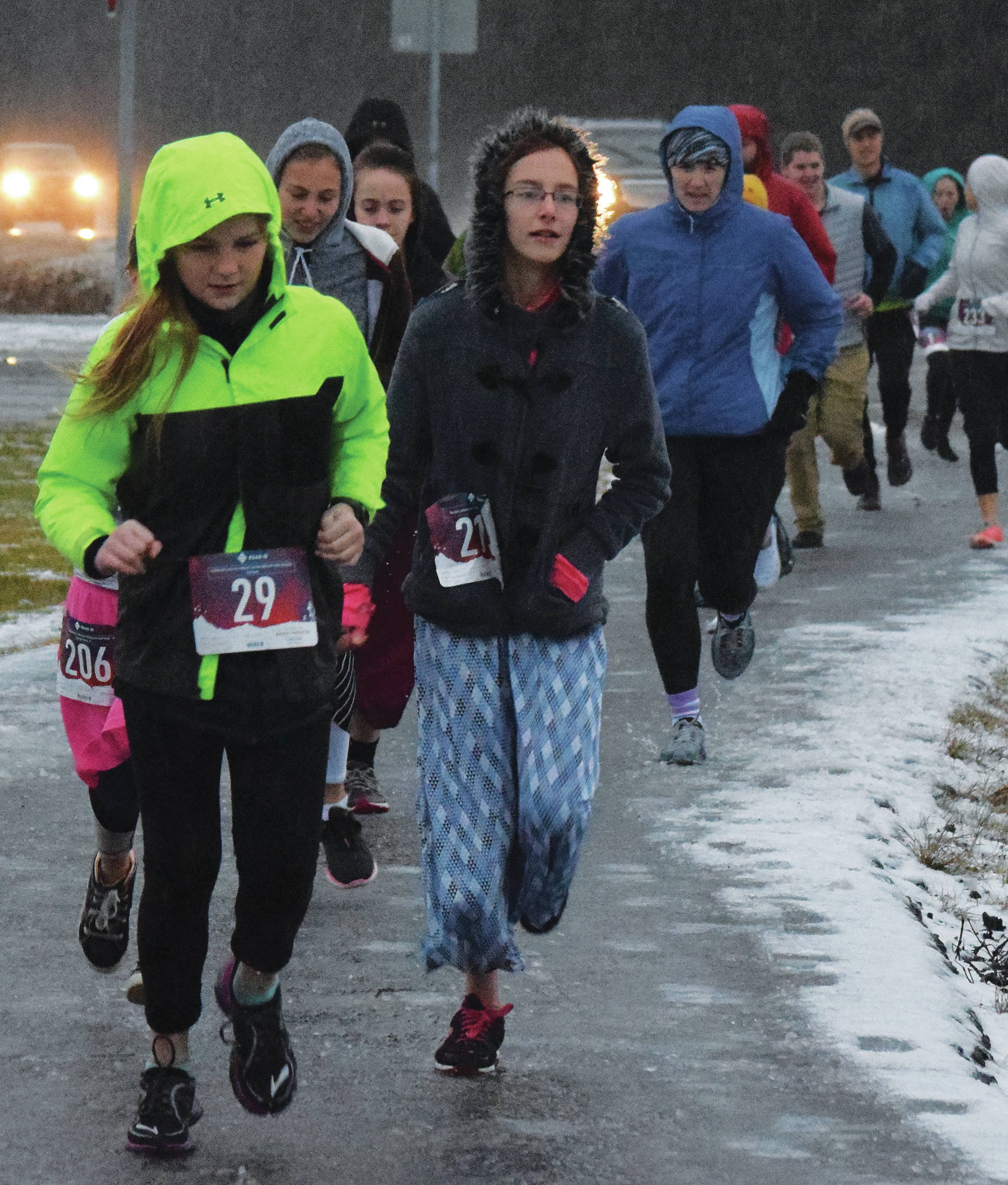 Two runners race together early Thursday, Nov. 28, 2019, at the Turkey Trot in Soldotna, Alaska. (Photo by Joey Klecka/Peninsula Clarion)