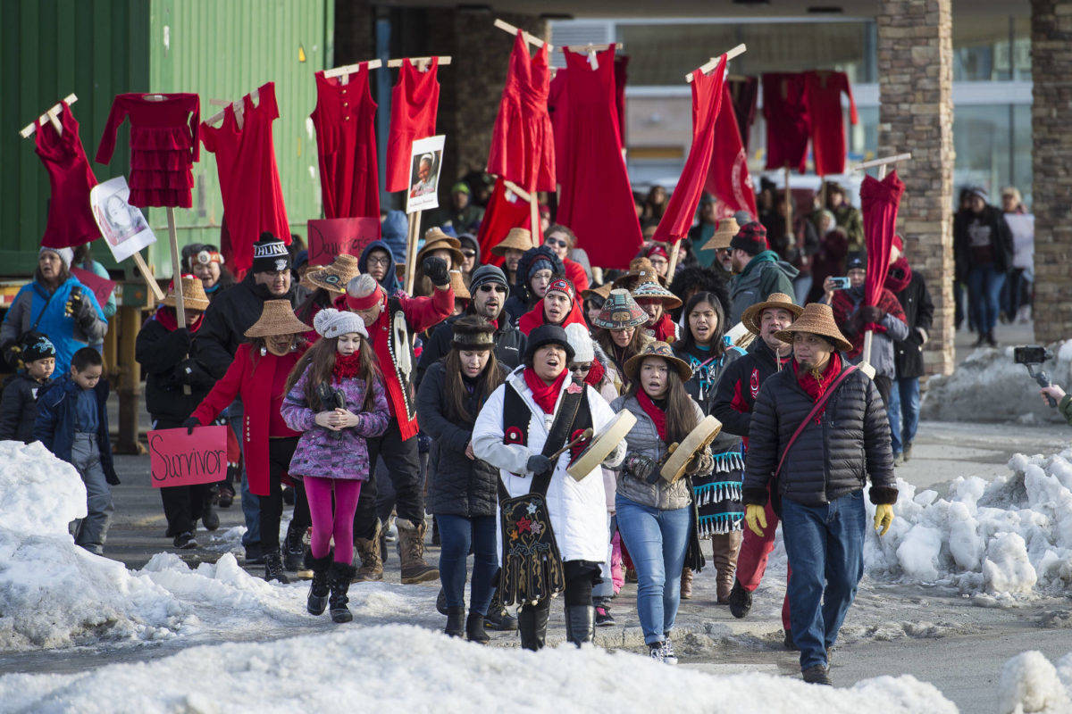 Juneau residents march, holding up red dresses to symbolize missing and murdered indigenous women, during the Women’s March on Juneau in front of the Alaska State Capitol on Saturday, Jan. 19, 2019. (Michael Penn | Juneau Empire File)