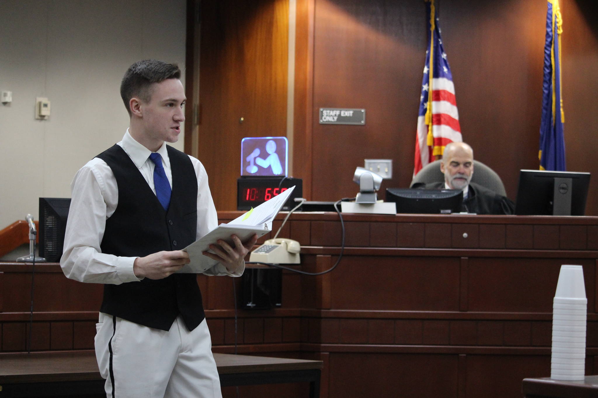 Nikiski Middle/High School senior Bryan McCollum, in his role as defense attorney, gives an opening statement to the jury during a mock trial at the Kenai Courthouse on Dec. 3, 2019. (Photo by Brian Mazurek/Peninsula Clarion)
