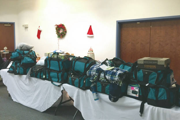 Thirty duffel bags filled by the Kenai Peninsula Association of Realtors for children in the Kenai Peninsula Borough School District’s Students in Transition Program are photographed in December 2018 in Kenai, Alaska. (Photo courtesy of Kelly Martin)