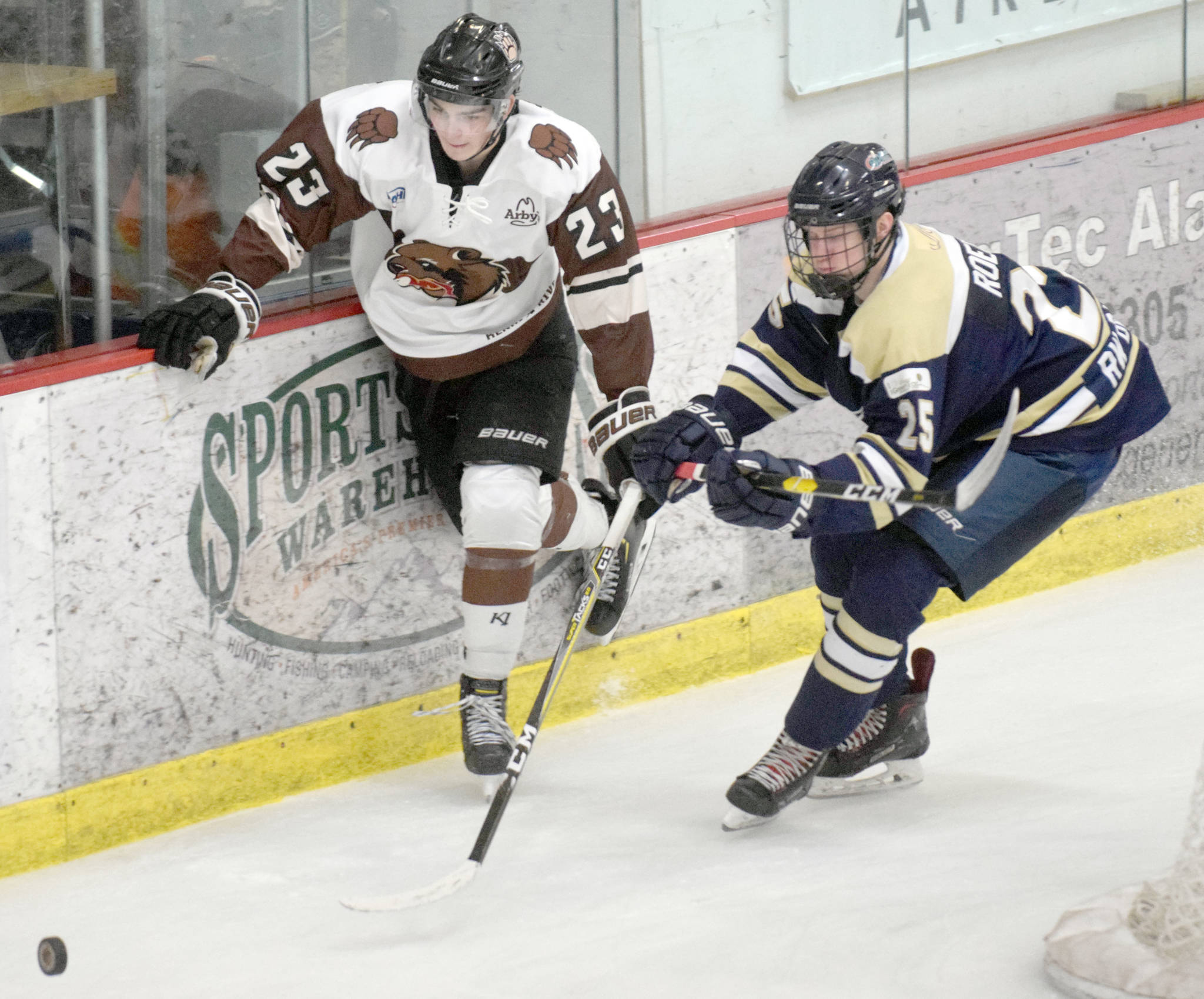 Kenai River Brown Bears defenseman Max Helgeson and Janesville (Wisconsin) Jets defenseman Casey Roepke battle for the puck Friday, Dec. 6, 2019, at the Soldotna Regional Sports Complex in Soldotna, Alaska. (Photo by Jeff Helminiak/Peninsula Clarion)