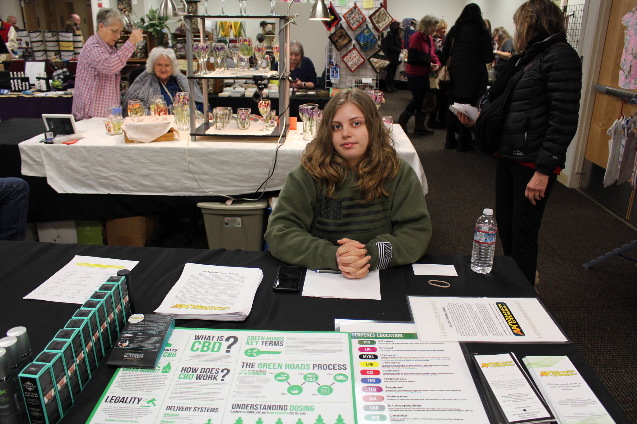 Vanessa Uie, owner of AK Wellness and Planning, displays some of her CBD products for sale at the annual Central Peninsula Hospital Auxiliary Holiday Bazaar in Soldotna, Alaska on Dec. 6, 2019. (Photo by Brian Mazurek/Peninsula Clarion)