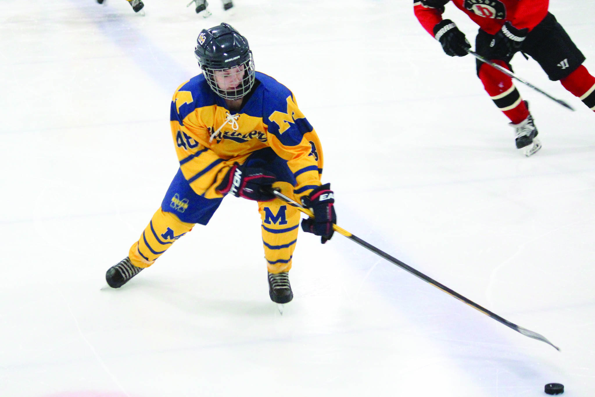 Homer’s Fiona Hatton reaches for the puck during a Friday, Dec. 6, 2019 hockey game against Juneau-Douglas High School at the Kevin Bell Arena in Homer, Alaska. (Photo by Megan Pacer/Homer News)