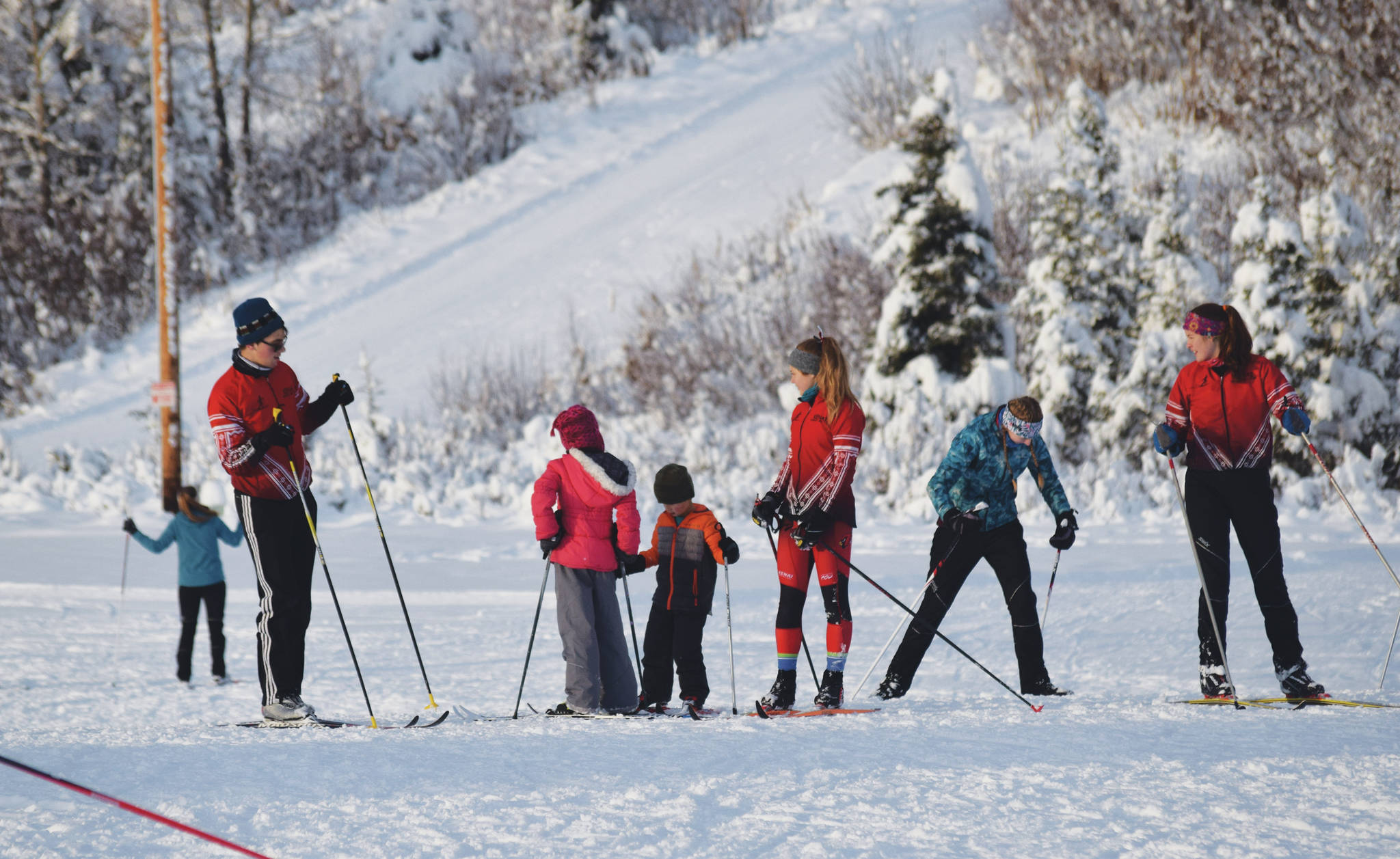 A group of Kenai Central High School skiers teach lessons to youth skiers Saturday at the Black Stone Axe Ridge Warm Up Rally at the Tsalteshi Trails in Soldotna. (Photo by Joey Klecka/Peninsula Clarion)