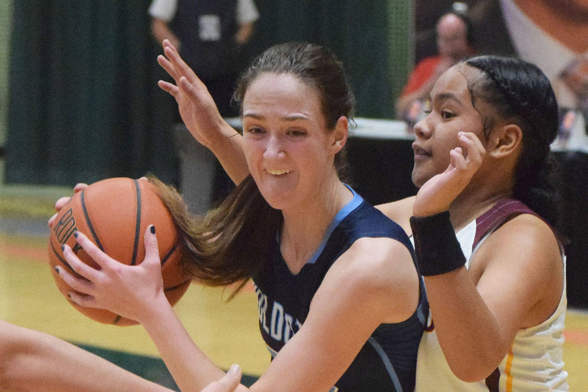 Soldotna’s Danica Schmidt (left) drives into the lane by Dimond’s Dshanna Schuster Friday, March 22, 2019, in the Class 4A state basketball tournament at the Alaska Airlines Center in Anchorage. (Photo by Joey Klecka/Peninsula Clarion)