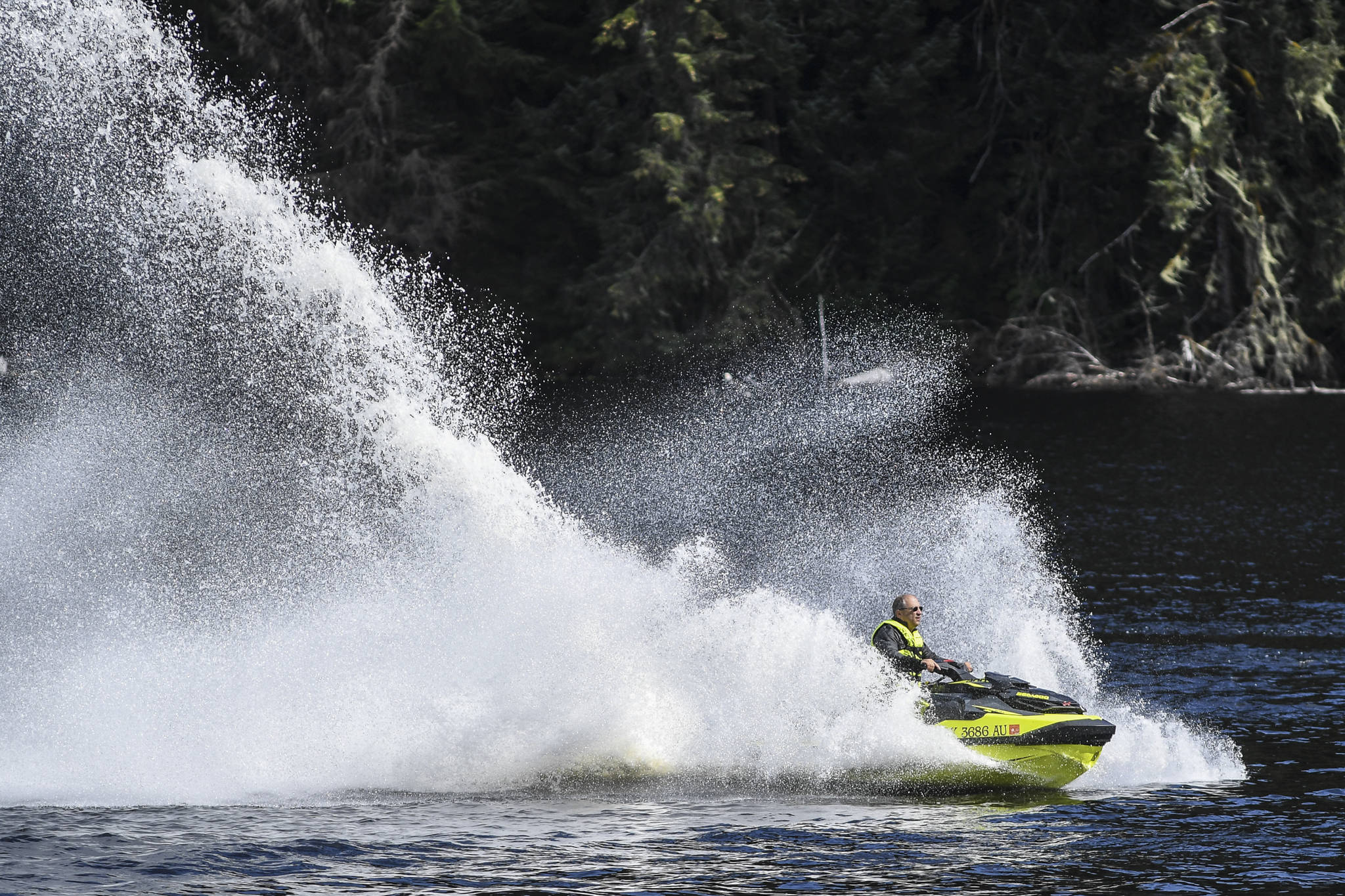 Terry Allen rides his jet ski at Auke Lake near Juneau on Monday, Aug. 19, 2019. (Michael Penn | Juneau Empire)