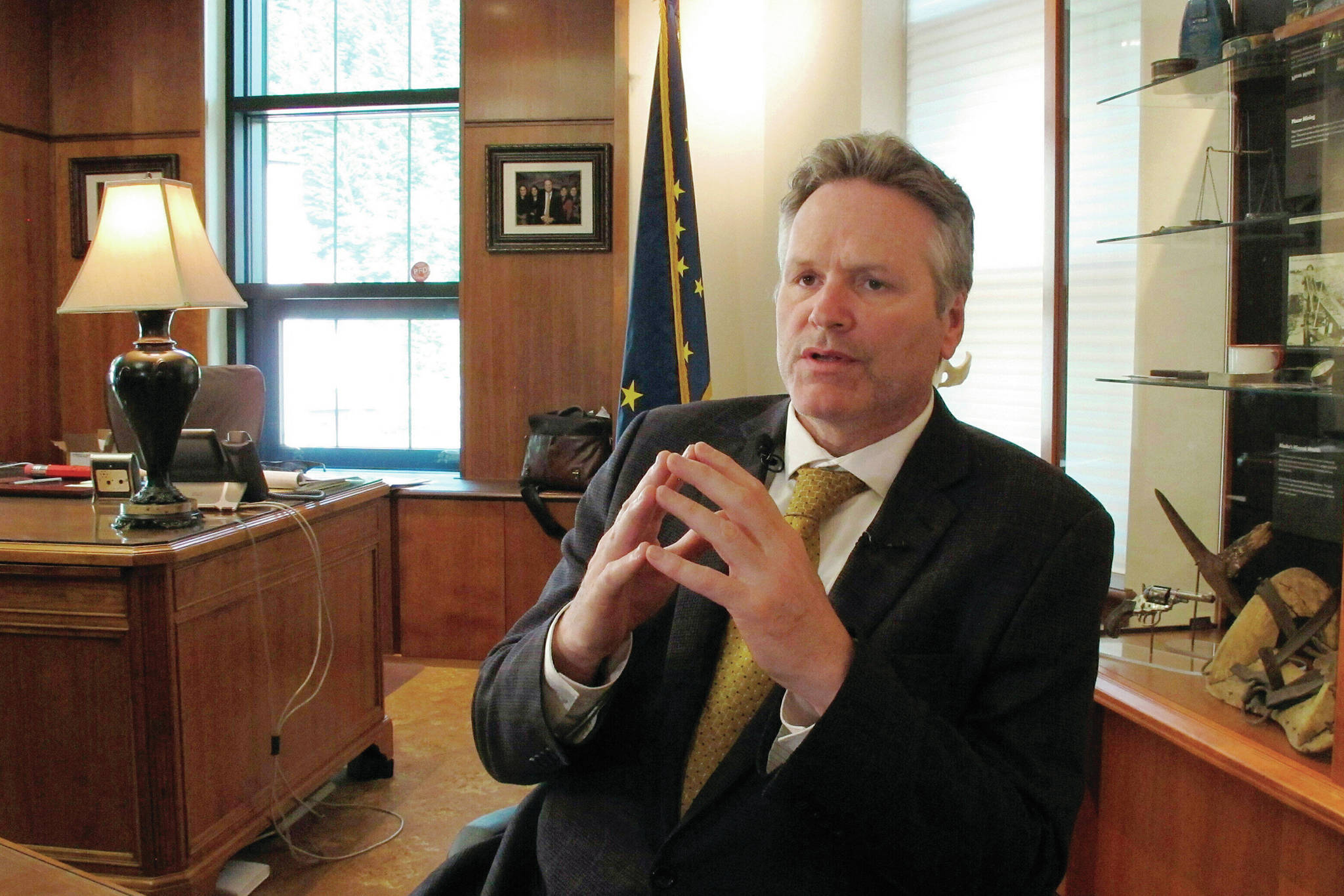 In this May 29, 2019 file photo, Alaska Gov. Mike Dunleavy speaks to reporters in his office at the state Capitol in Juneau, Alaska. (AP Photo/Becky Bohrer, File)