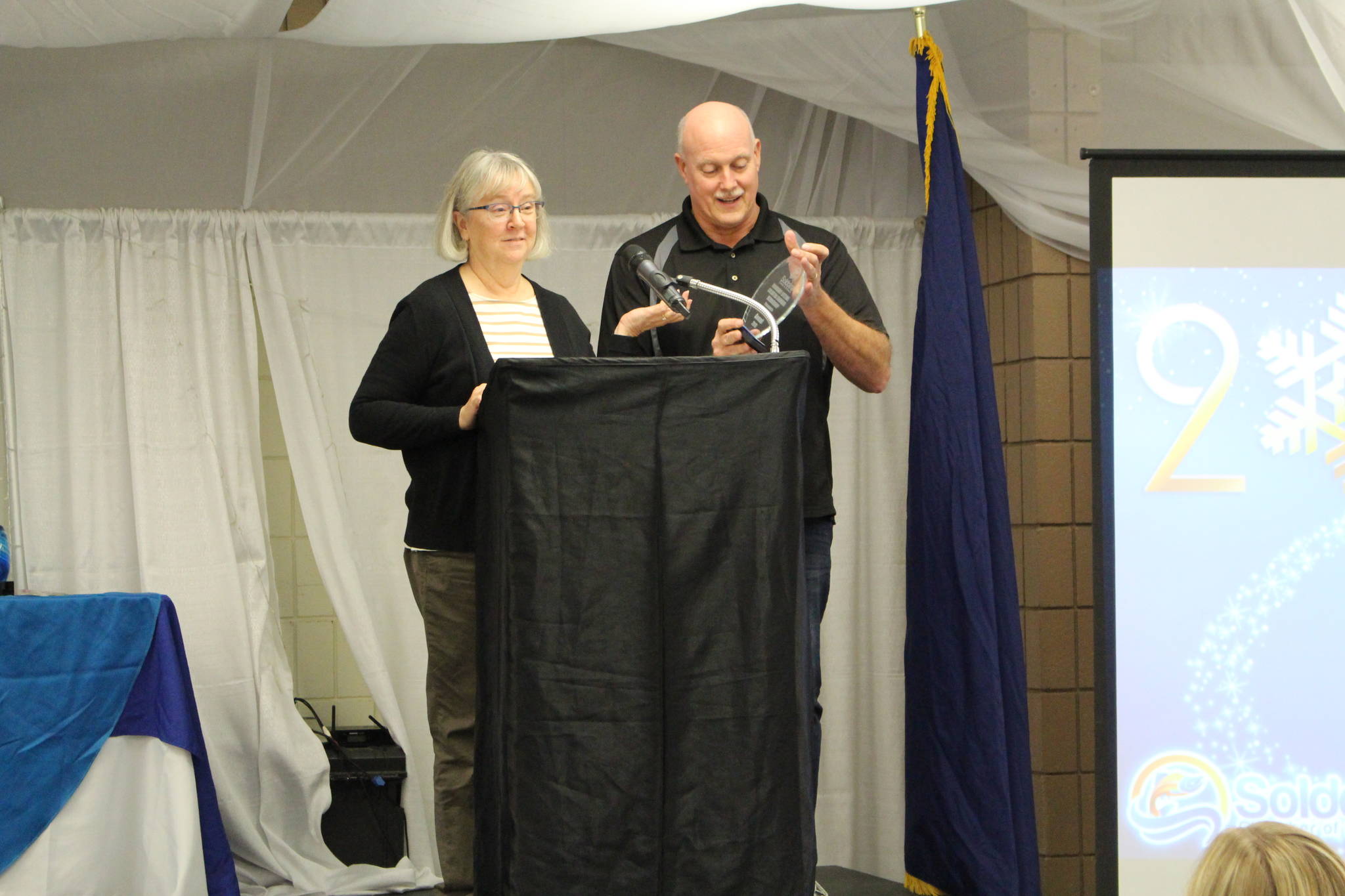 Kathy and Dan Gensel accept their award for Honorary Lifetime Soldotna Chamber Membership at the Soldotna Chamber of Commerce Awards Luncheon at the Soldotna Regional Sports Complex on Dec. 11, 2019. (Photo by Brian Mazurek/Peninsula Clarion)