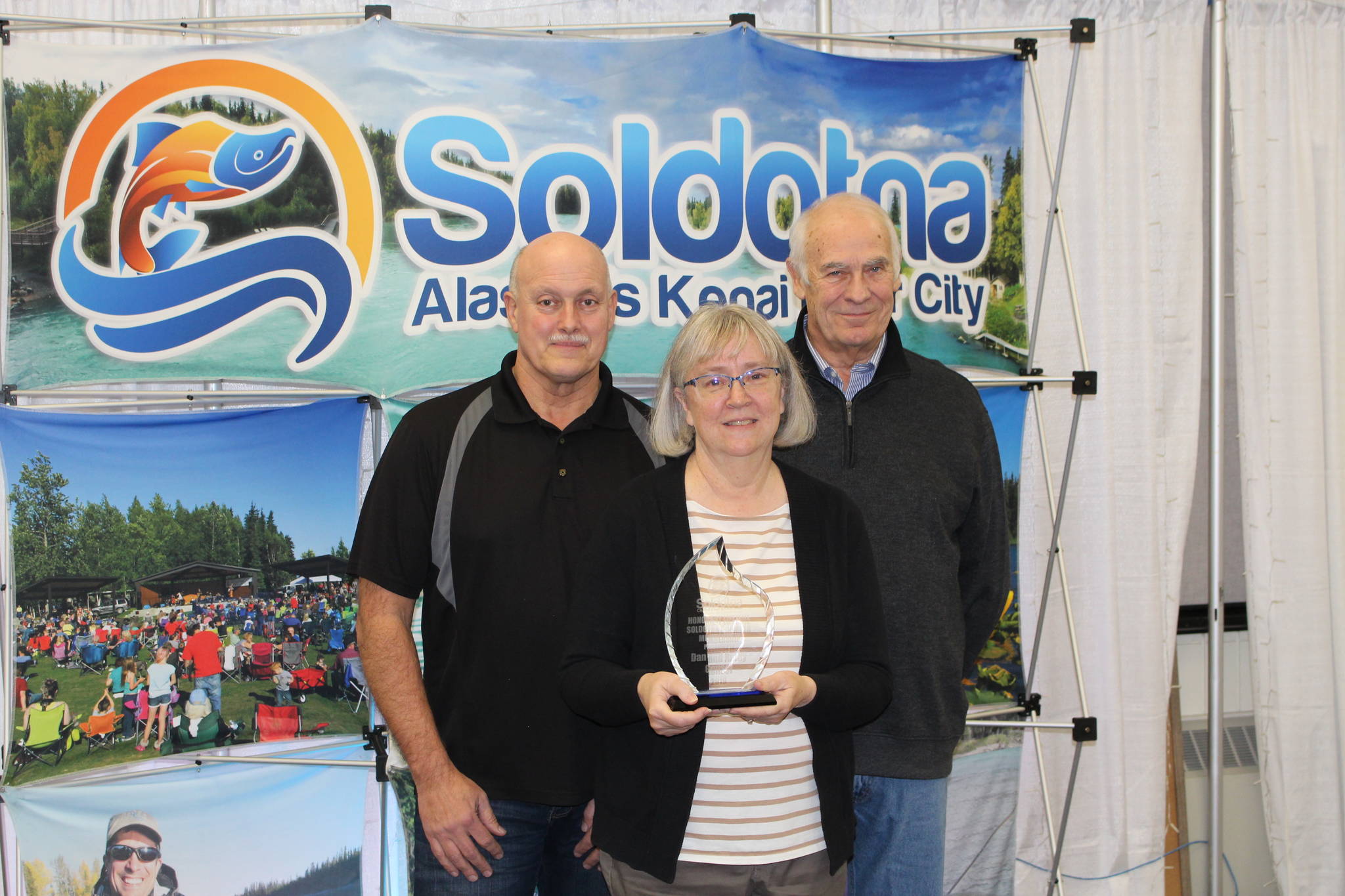 Dan Gensel, Kathy Gensel and Chamber President Jim Stogsdill smile for the camera at the Soldotna Chamber of Commerce Awards Luncheon at the Soldotna Regional Sports Complex on Dec. 11, 2019. (Photo by Brian Mazurek/Peninsula Clarion)
