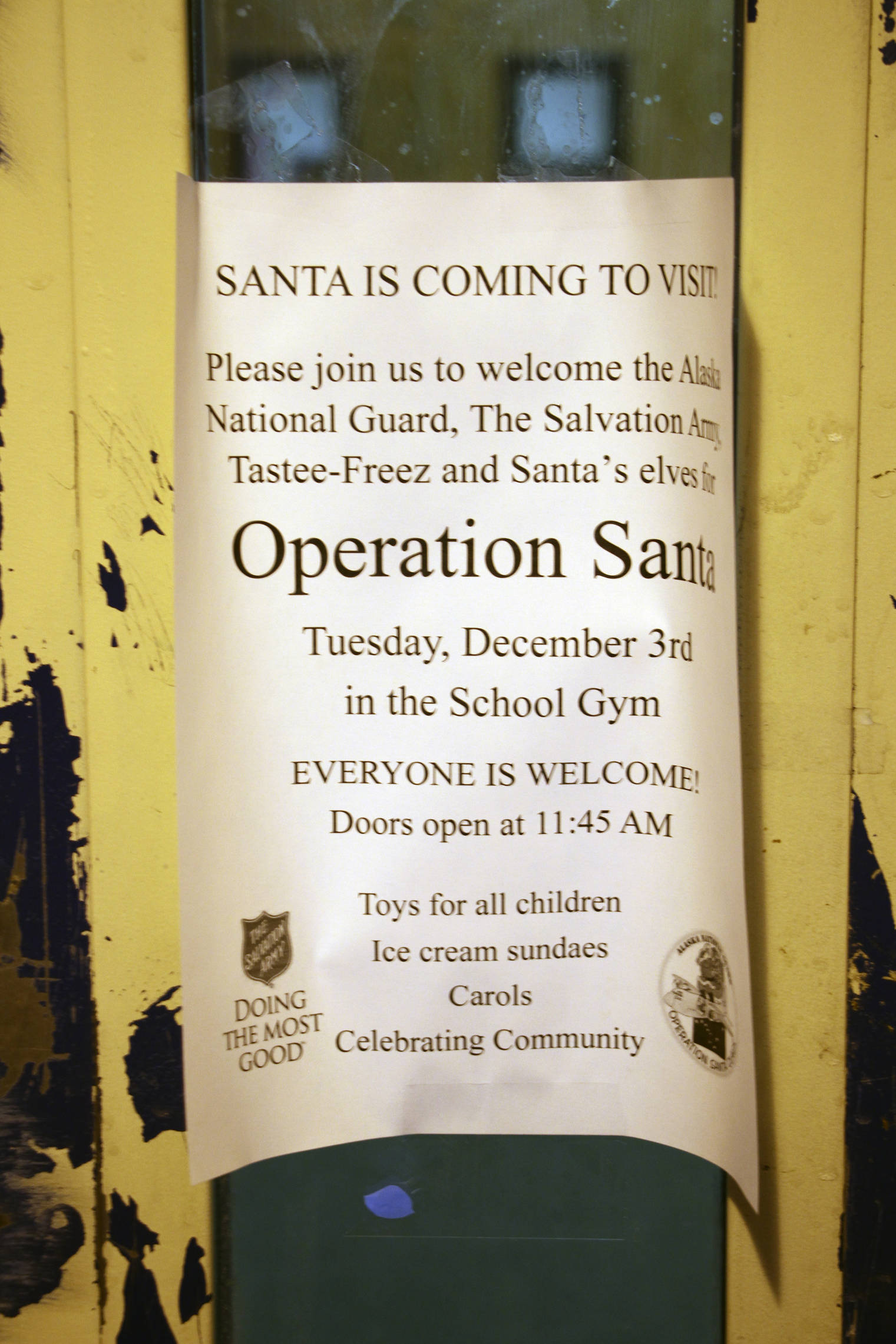 This Dec. 3, 2019, photo shows a sign posted on the door of the public school in Napakiak, Alaska. The Alaska National Guard brought its Operation Santa Claus to the western Alaska community, which is being severely eroded by the nearby Kuskokwim River. (AP Photo/Mark Thiessen)
