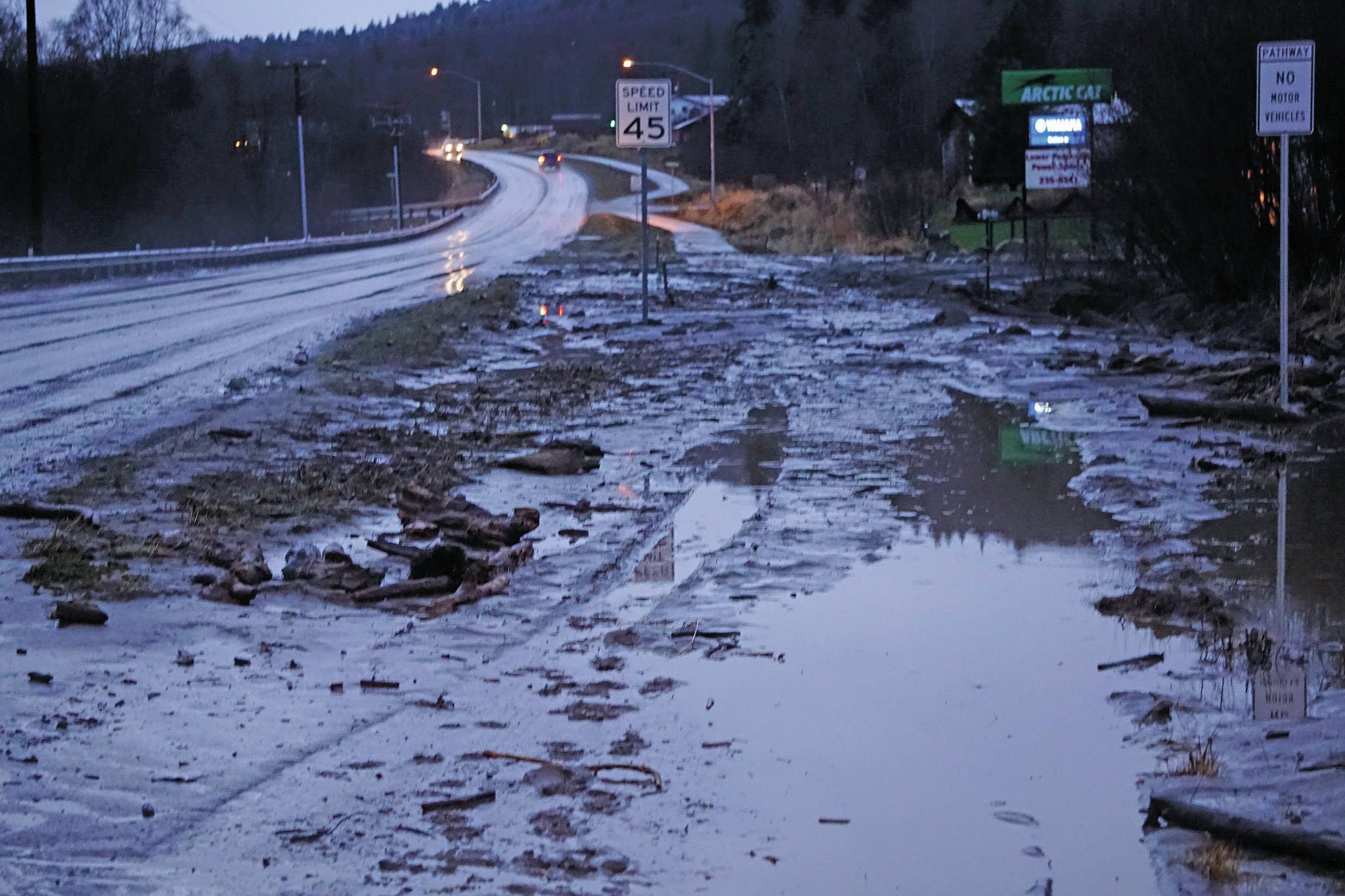 Mud and debris is washed up at Bear Creek near East End Road on Monday afternoon, Dec. 9, 2019, in Homer, Alaska. Bear Creek crosses East End Road near Bear Creek Drive and overflowed the creek banks. (Photo by Michael Armstrong/Homer News)